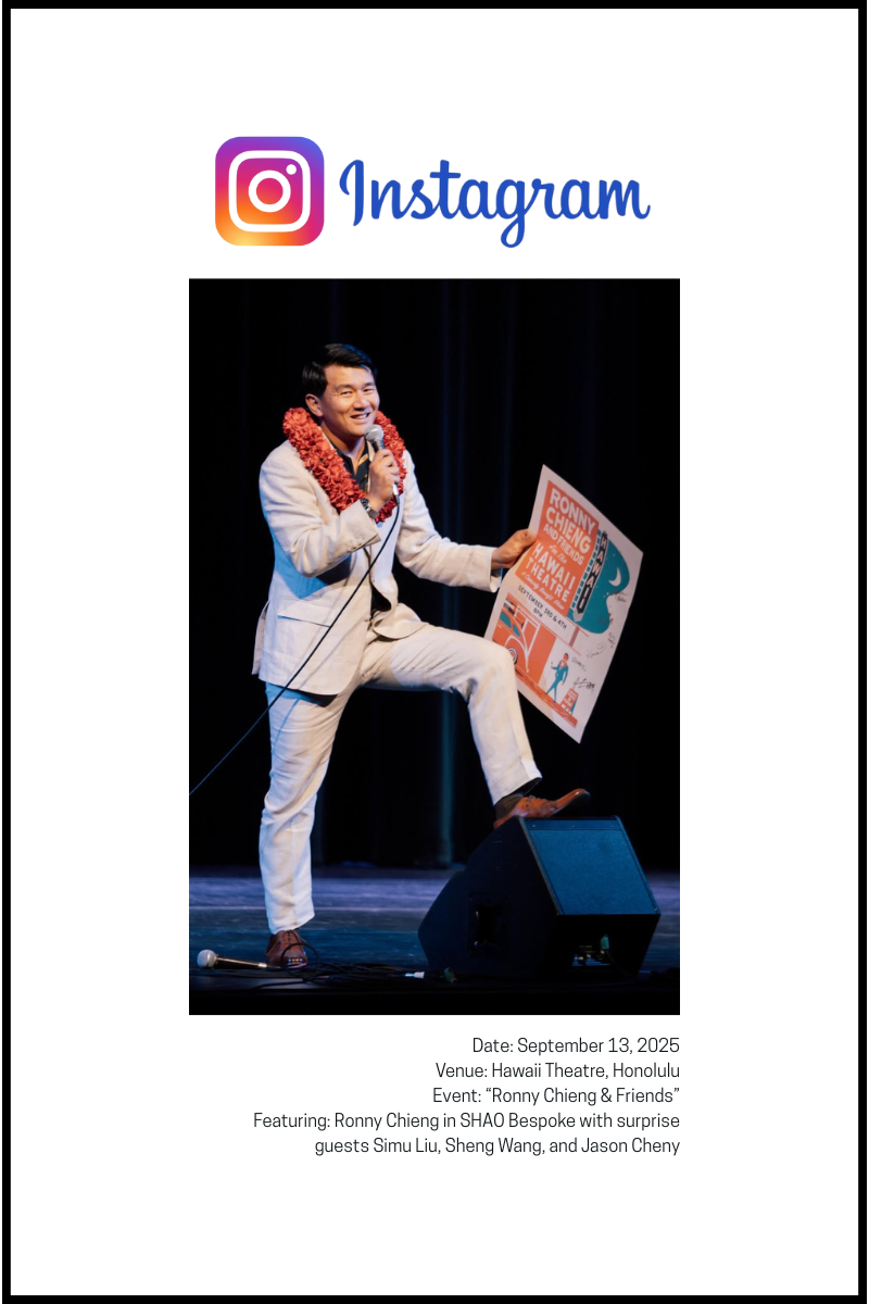 man in white suit holding microphone