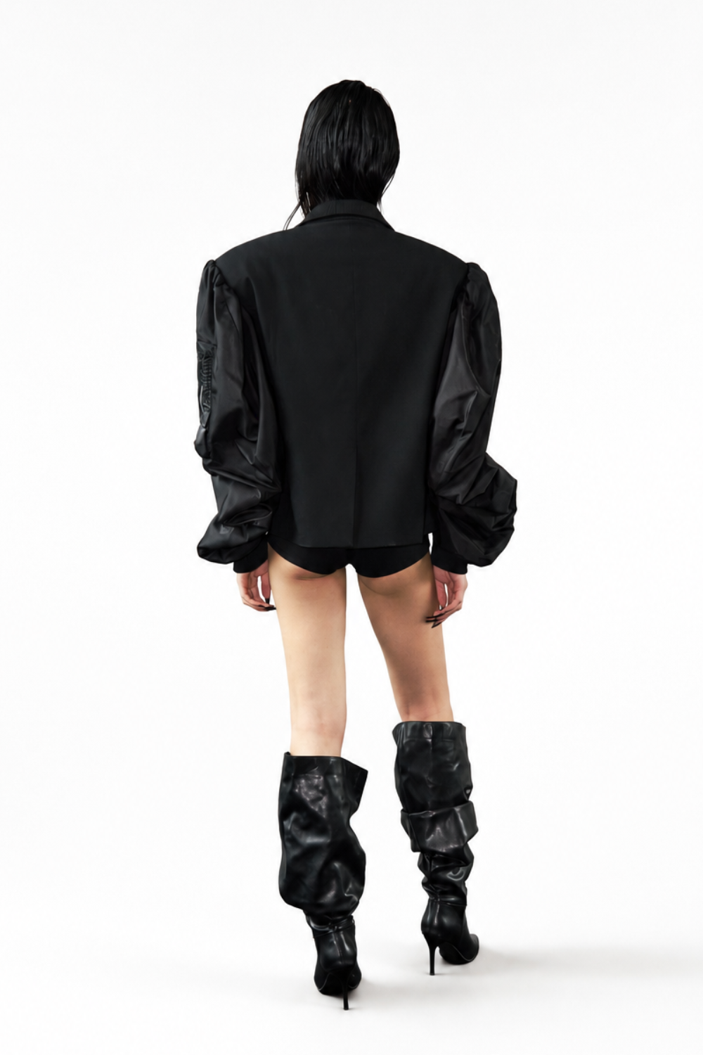 Model showcasing the Hybrid Bomber Sleeve Blazer from the back, featuring voluminous, ruched sleeves in contrasting fabric and a tailored, sharply structured body, embodying SHAO New York bespoke tailoring and luxury designer fashion with a modern sculptural silhouette.