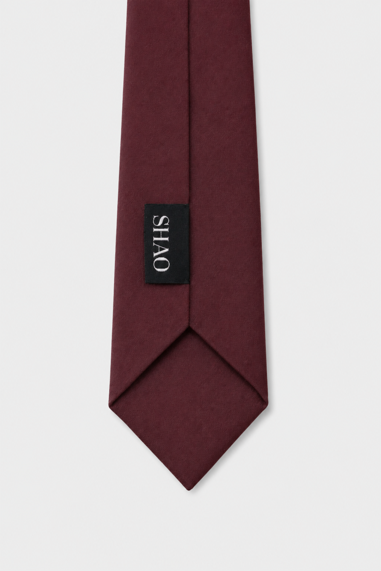 Wool Tie 7.5 cm in rich burgundy with a luxurious matte finish, showcasing SHAO New York’s expert craftsmanship in bespoke tailoring and refined luxury fashion.