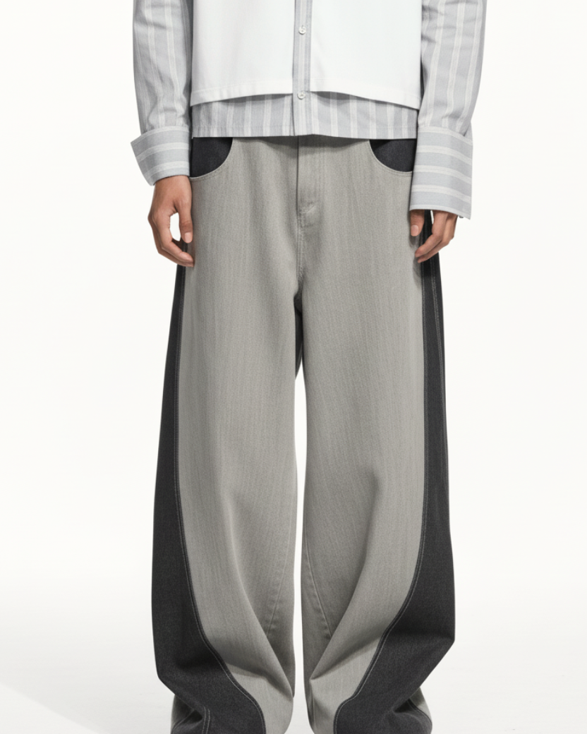 Front view of Dual-Tone Curvilinear Denim Jeans featuring a wide-leg silhouette with contrasting dark and light denim panels, sculptural curved lines, and expert bespoke tailoring by SHAO New York.