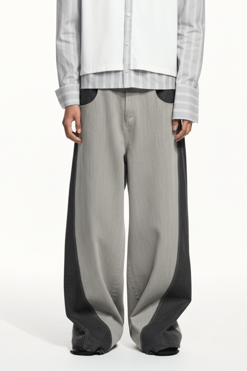 Front view of Dual-Tone Curvilinear Denim Jeans featuring a wide-leg silhouette with contrasting dark and light denim panels, sculptural curved lines, and expert bespoke tailoring by SHAO New York.