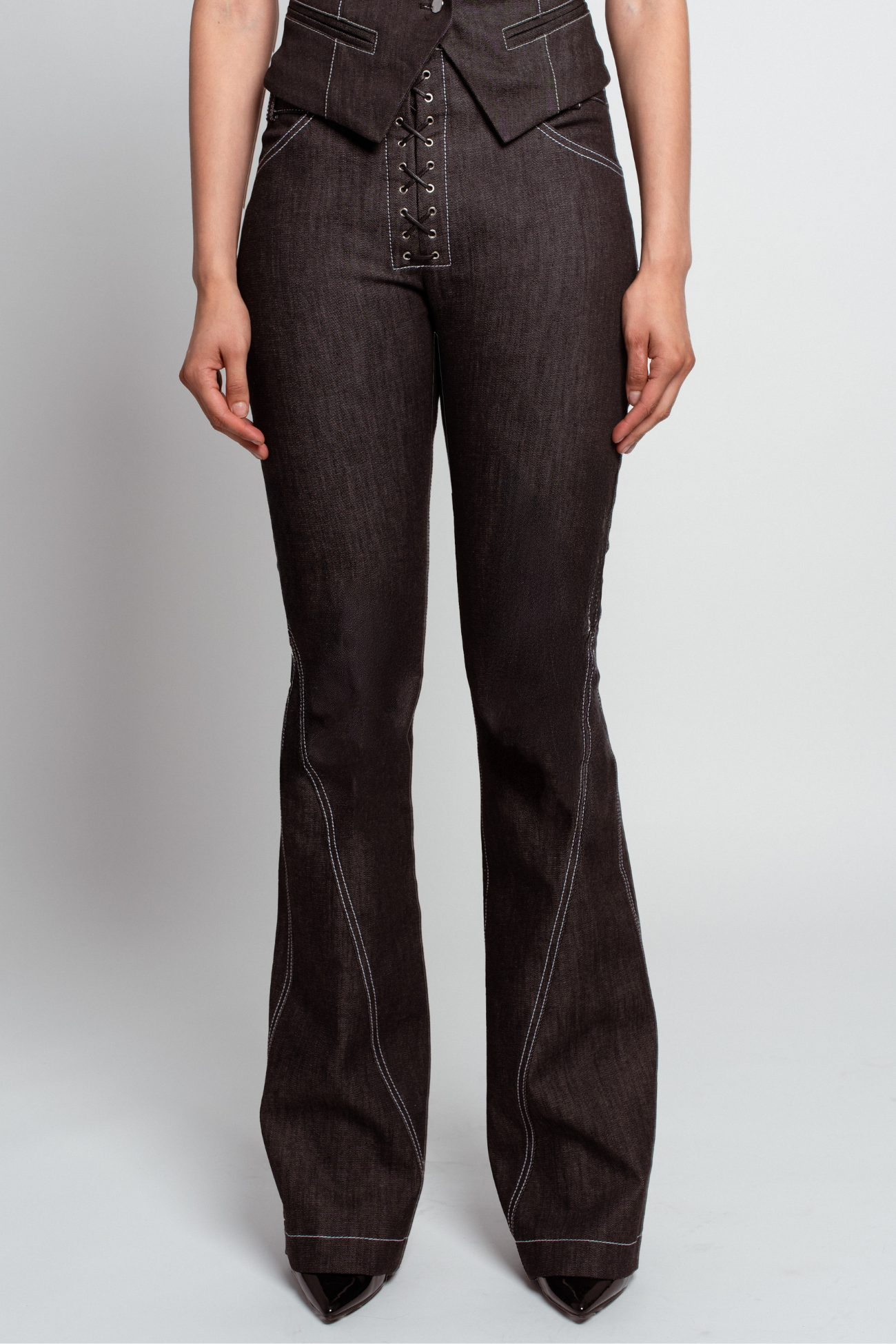 Dark Grey Lace-Up Flare Denim Trousers featuring contrast stitching, a high-rise silhouette with tailored flare legs, and a lace-up front closure for a tailored, sculptural luxury designer fashion look.