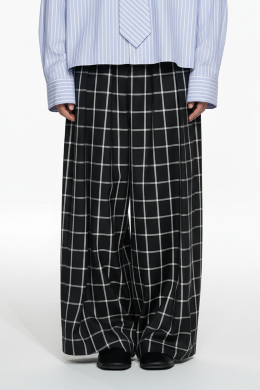 Front view of Windowpane Wide-Leg Double-Pleated Trousers featuring a striking black base with contrasting white windowpane grid, wide legs, and expertly crafted bespoke tailoring by SHAO New York.