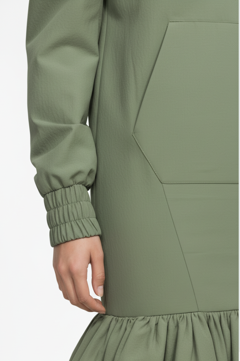 Close-up of Sage Green Utility Anorak Jacket Dress sleeve featuring elastic cuffs and part of a front pocket, highlighting its textured fabric and precise tailoring in luxury designer fashion by SHAO New York.