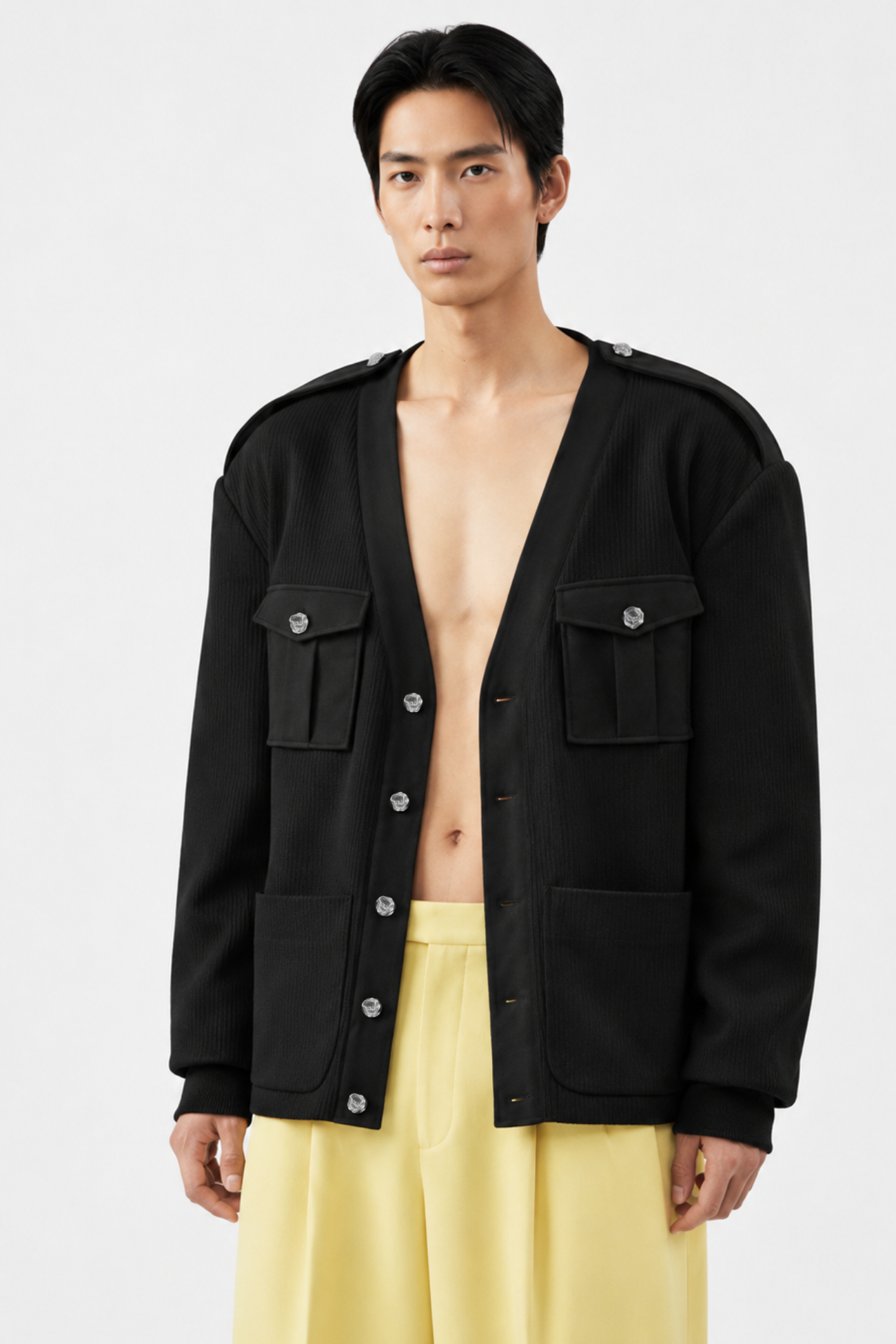 Front view of Black Military-Style Utility Cardigan with pronounced flap chest pockets and silver buttons, featuring a deep V-neck and relaxed fit, highlighting SHAO New York bespoke tailoring and luxury designer fashion.