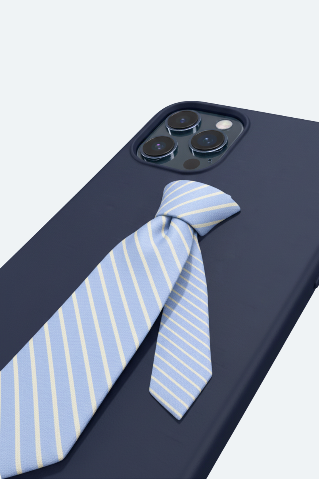Striped Tie Phone Case Limited Edition showcasing a deep navy base with a sculptural light blue and white diagonal tie detail, inspired by bespoke New York designer tailoring.