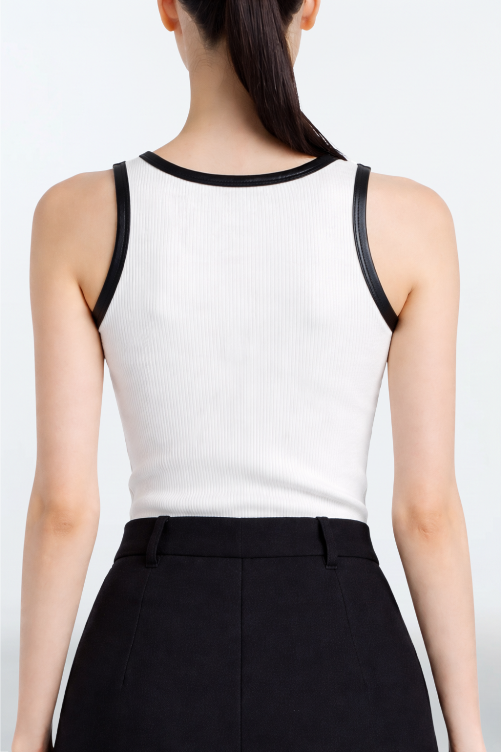 White Rib-Knit Tank Top with Leather Trim featuring contrasting black leather edging around neck and armholes, displaying SHAO New York’s refined designer craftsmanship and tailored fit.