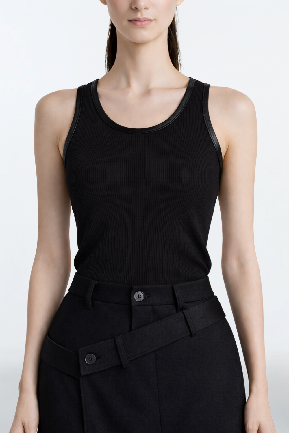 Black Rib-Knit Tank Top with Leather Trim featuring a fitted ribbed texture and sleek leather edging along the neckline and armholes, reflecting SHAO New York’s luxury designer fashion with a modern tailored finish.