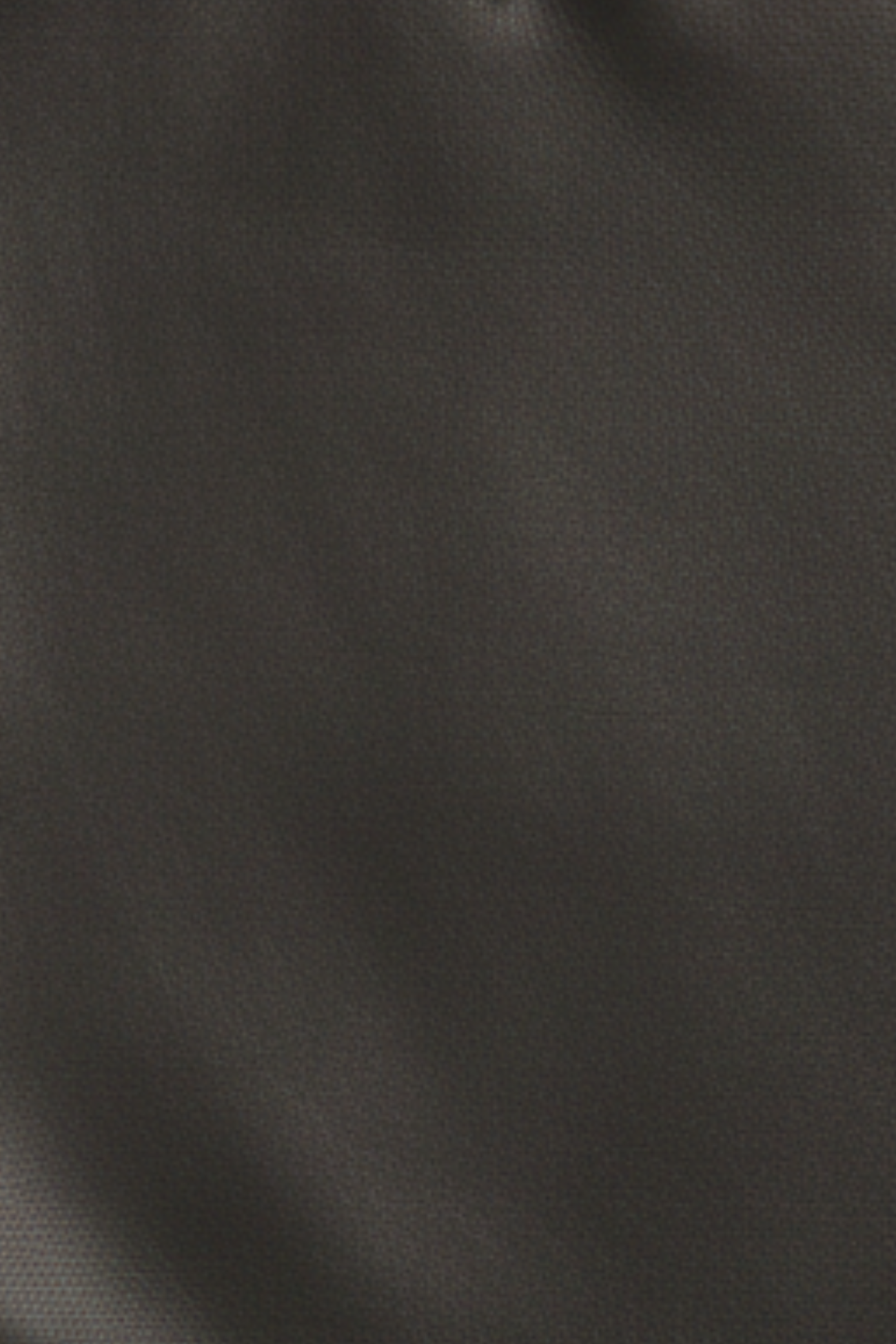 Close-up swatch of black leather with contrast white piping and structured wide-leg tailoring used for the trousers.