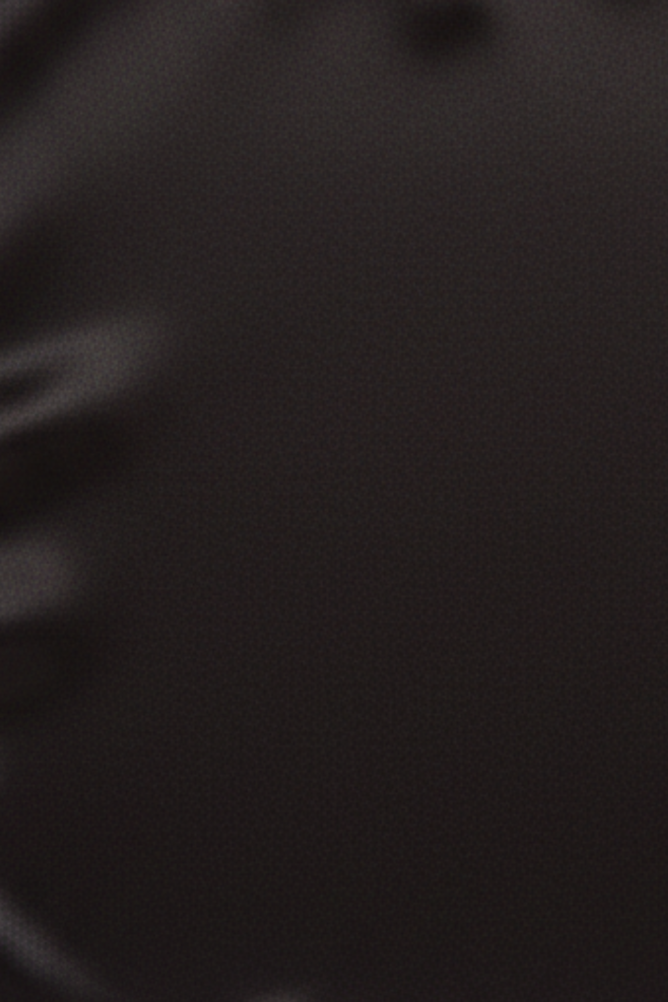 Close-up swatch of black denim and suiting fabric from hybrid trousers