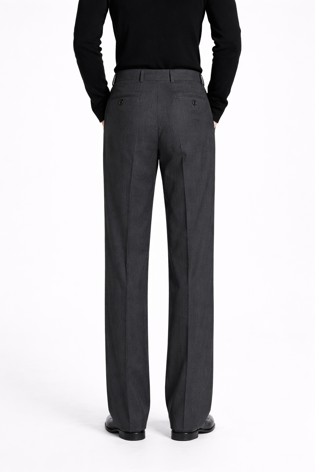 Back view of Charcoal Grey Relaxed Trousers featuring tailored rear welt pockets, a high waist, and a clean, elongated line that highlights bespoke tailoring and a sculptural silhouette.