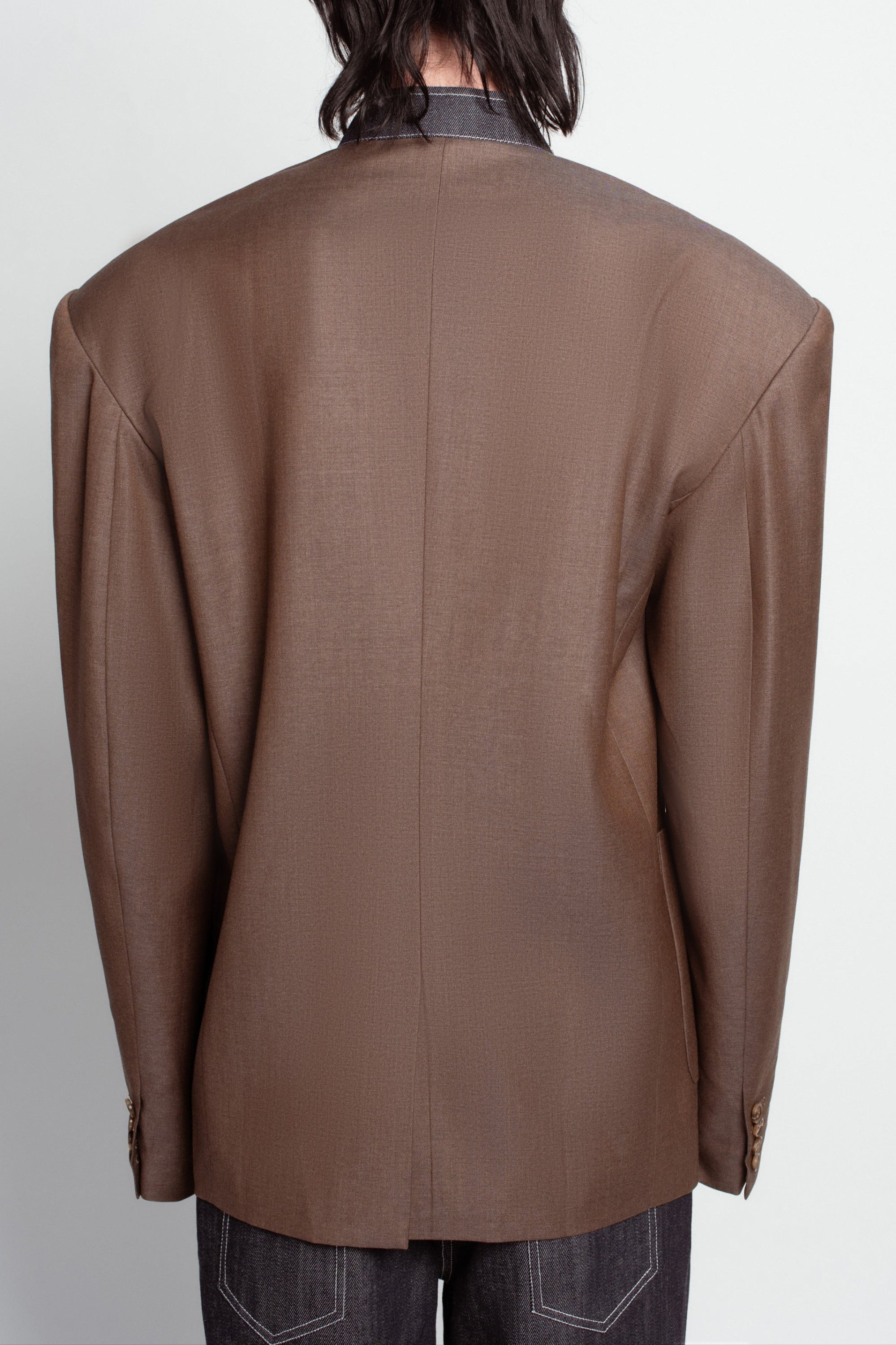 Back view of Warm Brown Oversized Blazer – Exposed Denim Dickie Detail with wide structured shoulders and clean lines, showcasing luxury designer fashion and bespoke New York tailoring.