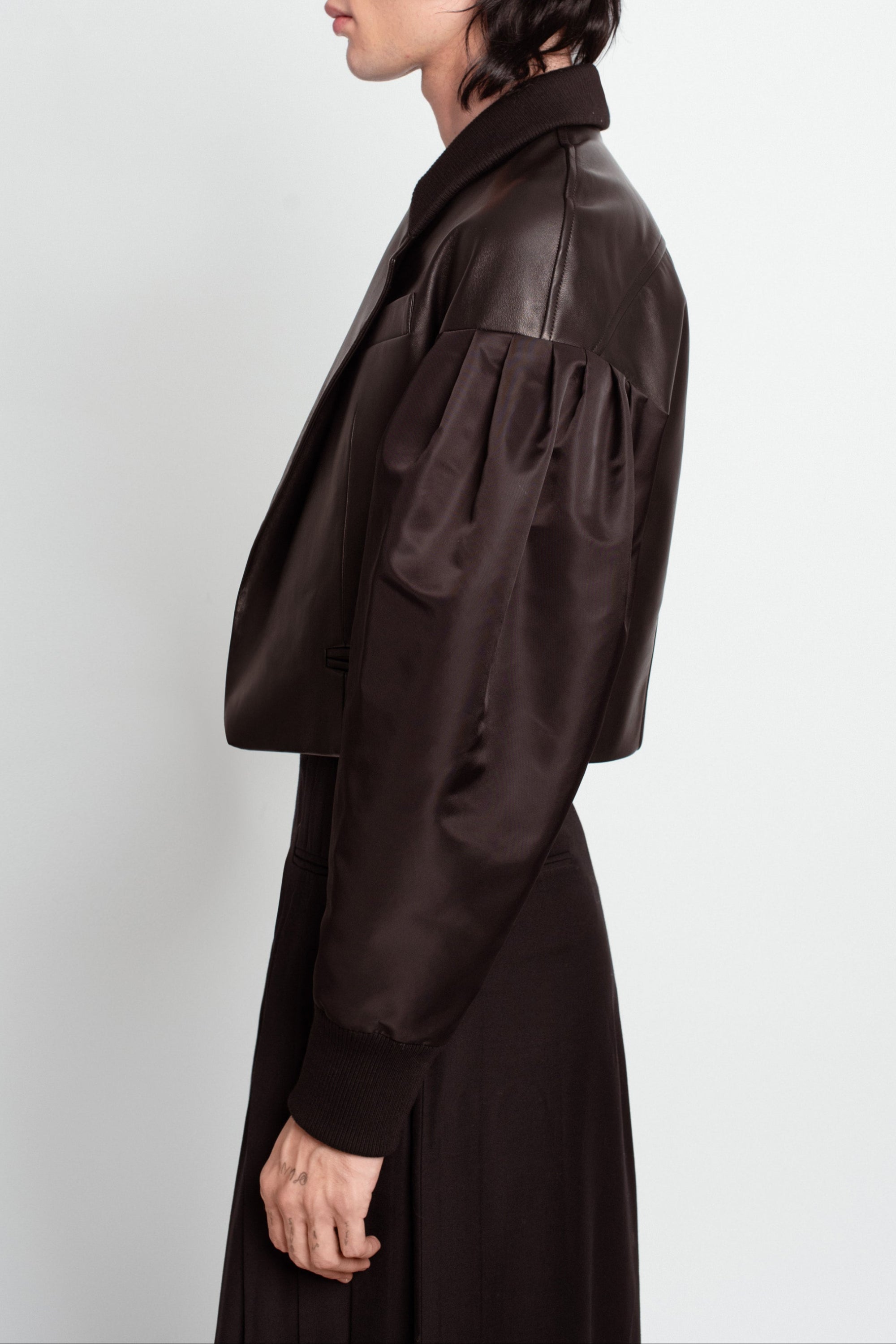 Side view of Jet Black Leather Bomber Jacket – Cropped Boxy Silhouette featuring gathered satin sleeves with leather yoke and structured collar, exemplifying SHAO New York bespoke tailoring and luxury designer fashion.