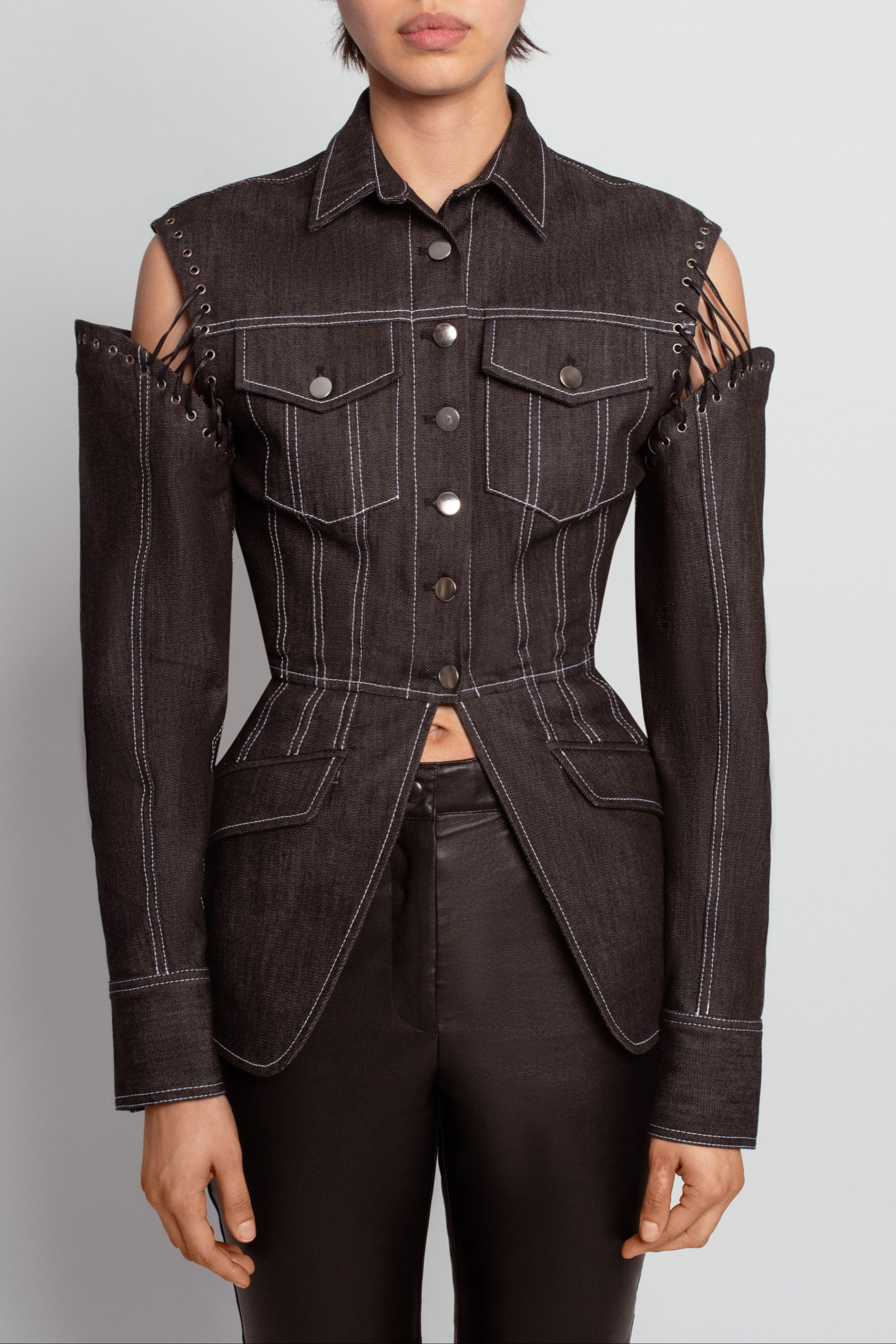 Front view of Midnight Blue Architectural Denim Jacket – Detachable Sleeve Design featuring exposed lacing at the shoulders, structured tailored fit, flap pockets, and contrast stitching for a sculptural silhouette in luxury designer fashion.