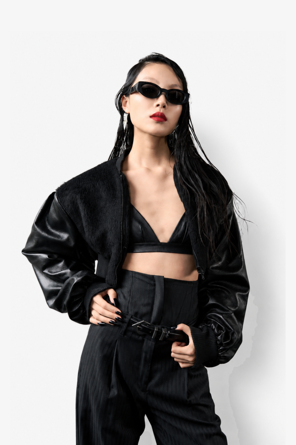 Model styled in the Cropped Alpaca and Leather Bomber Jacket paired with a sleek leather bralette and high-waisted tailored trousers, featuring SHAO New York’s luxury bespoke tailoring and a modern sculptural silhouette.