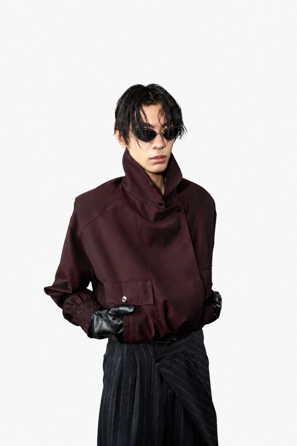 Model wearing Tailored Wool Balloon Bomber Jacket - Burgundy with a high collar and voluminous silhouette paired with pinstriped trousers and black leather gloves, showcasing SHAO New York bespoke tailoring and a sculptural silhouette.