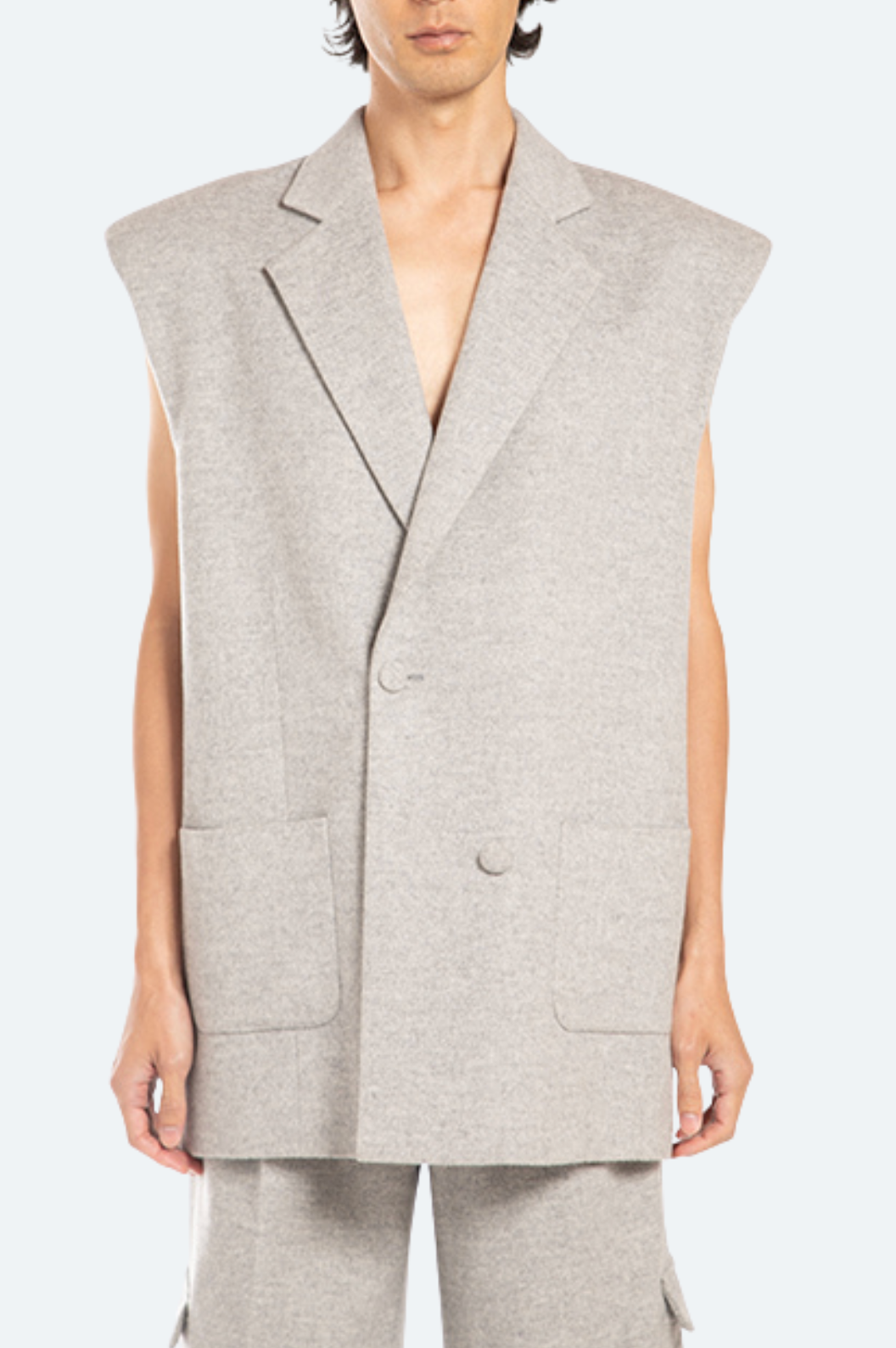 Front view grey wool flannel sleeveless blazer with wide shoulders and patch pockets