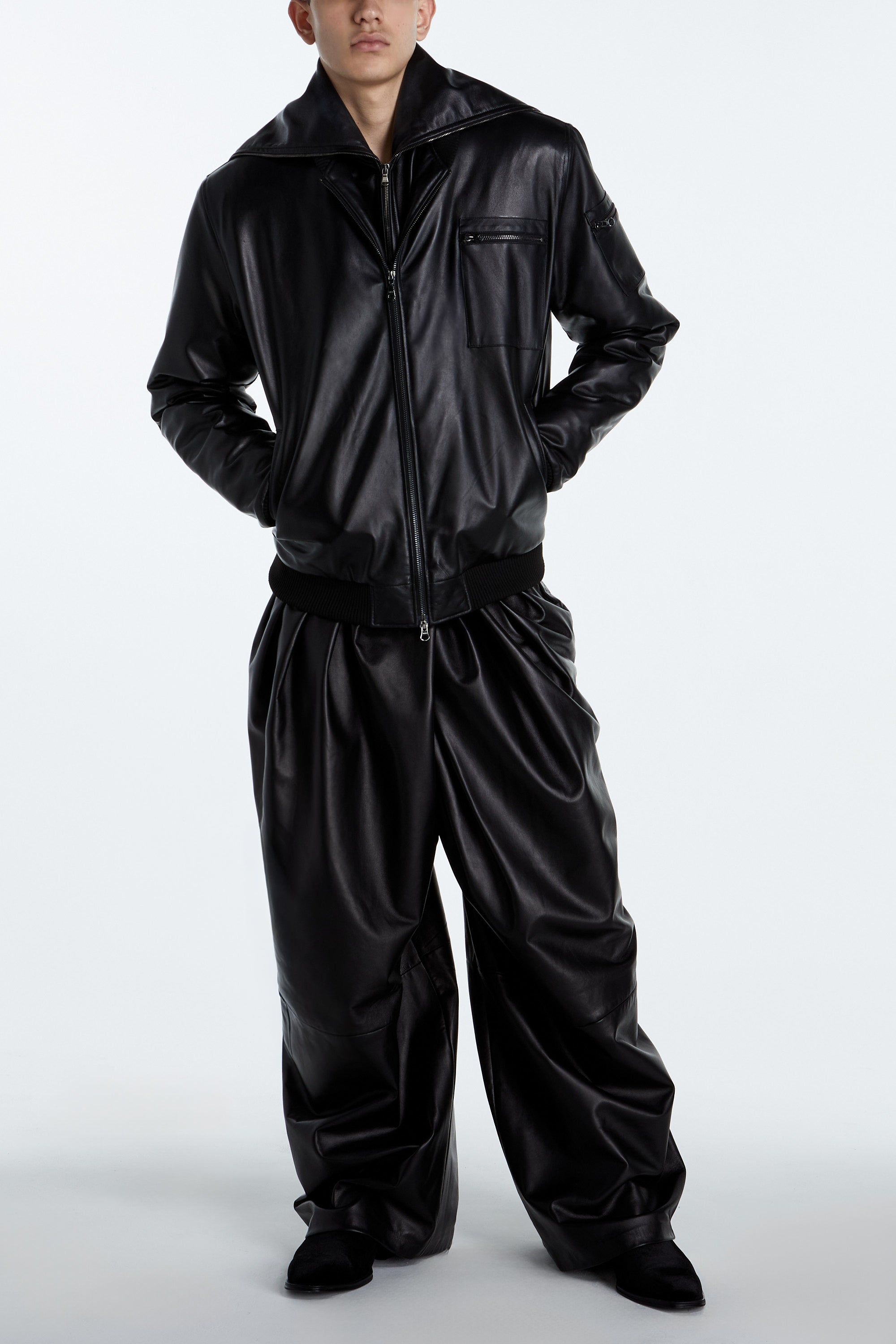 SHAO jet black leather asymmetrical pleated trousers front view