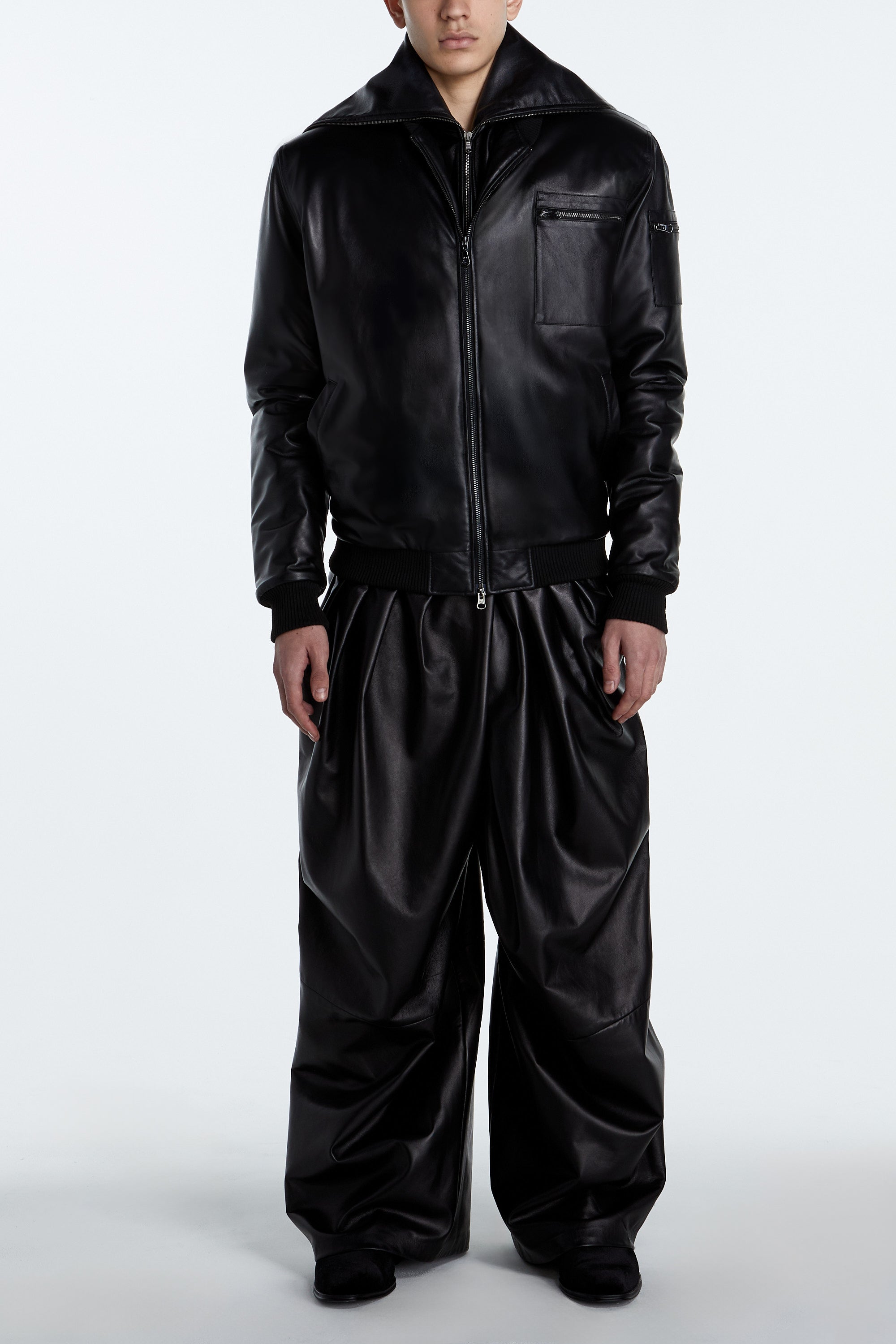 SHAO jet black leather asymmetrical pleated trousers whole view
