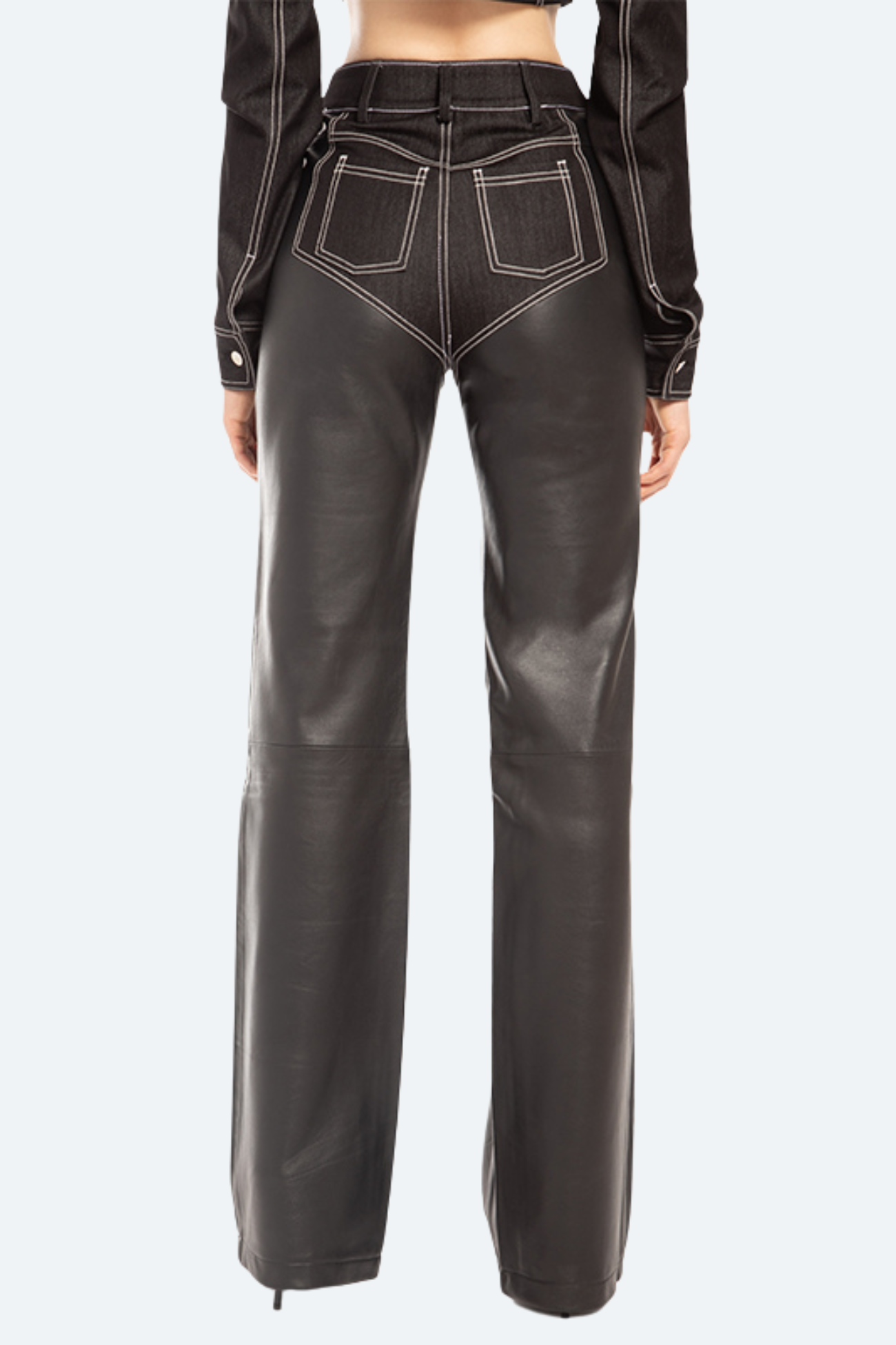 Back view of black leather trousers with straight-leg structure and architectural contrast piping