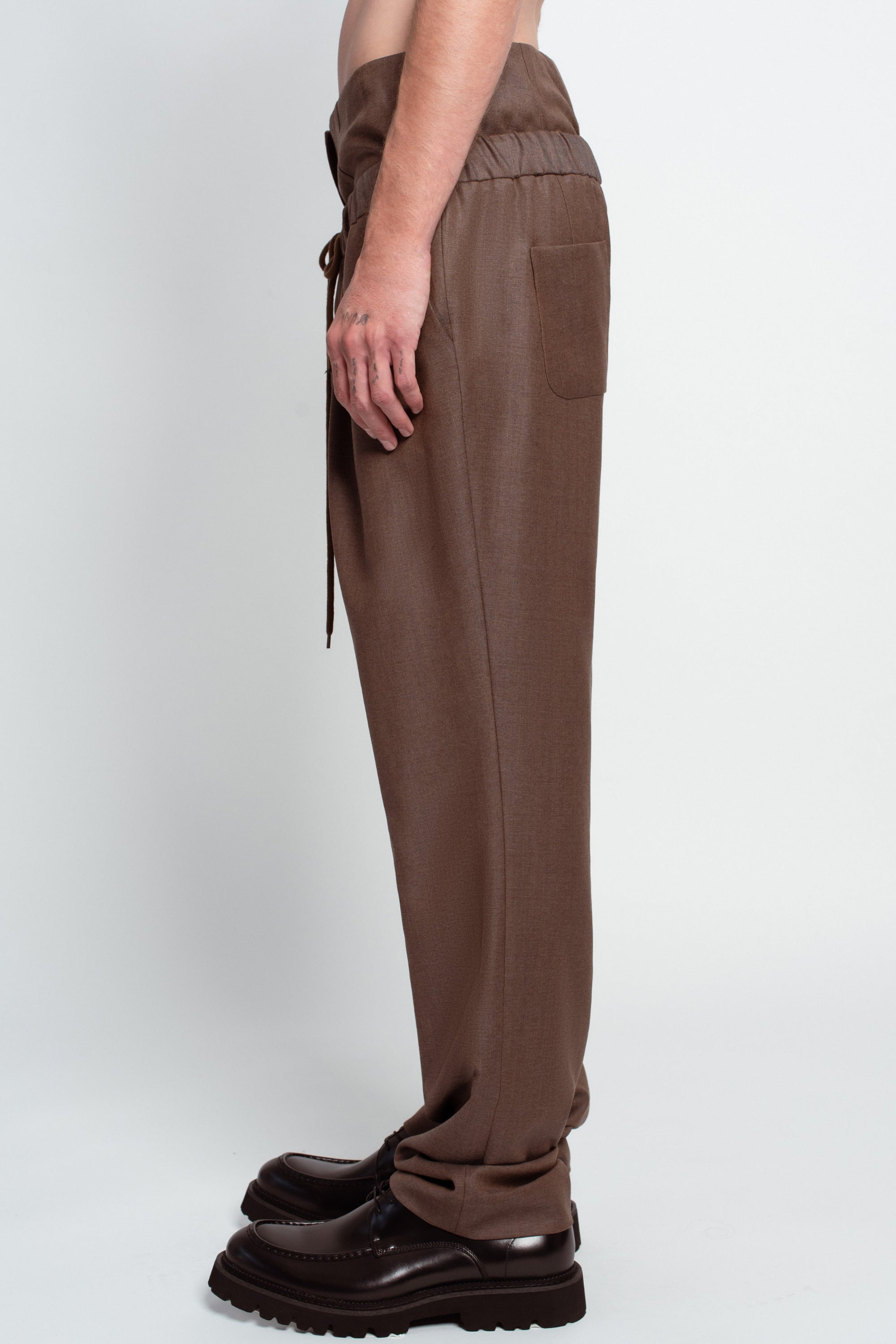 Brown wide-leg tailored trousers side view