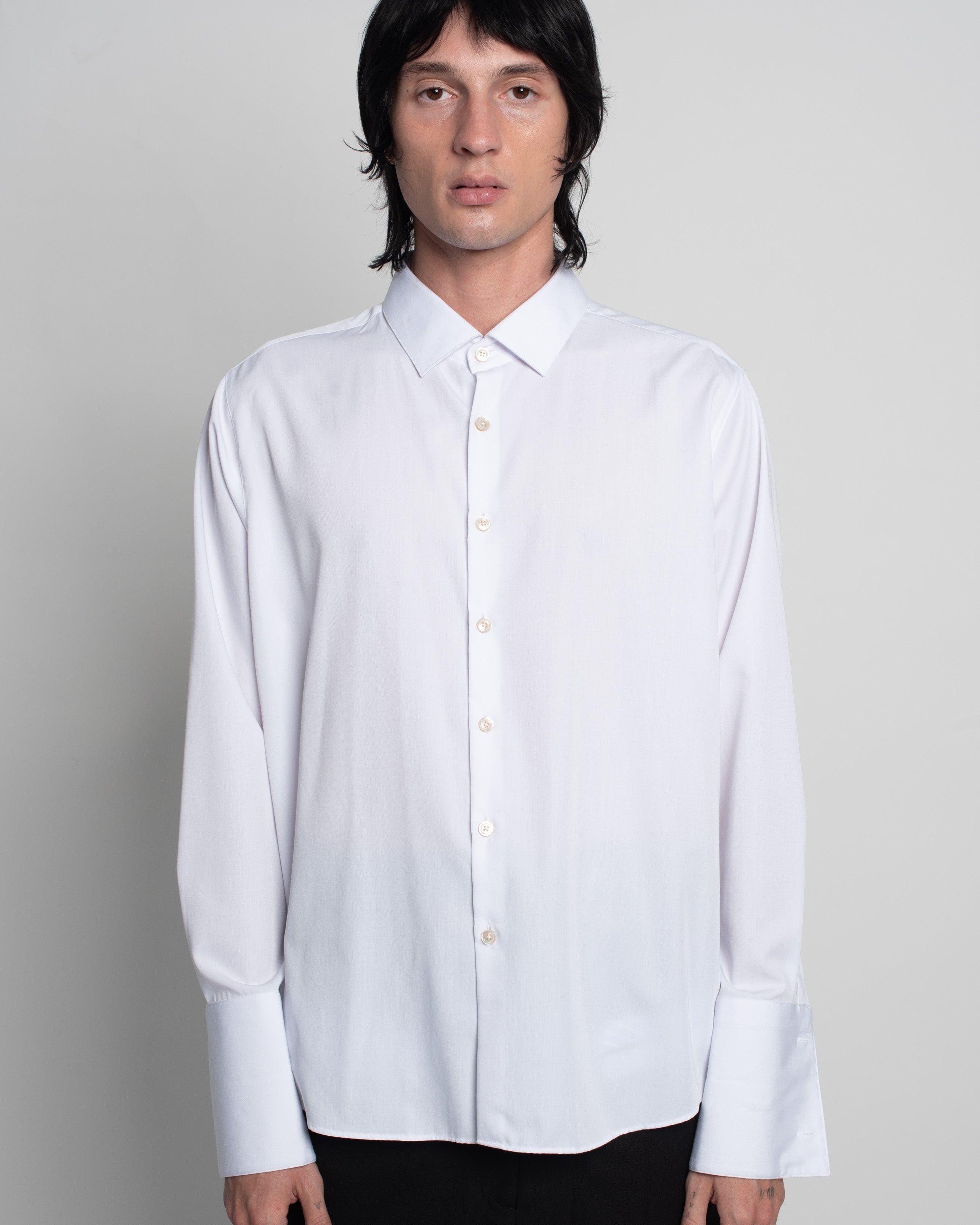 Front view of White Classic Button-Down Shirt in a relaxed fit featuring elongated cuffs, a sharp collar, and fine button detailing, exemplifying SHAO New York bespoke tailoring and luxury designer fashion.