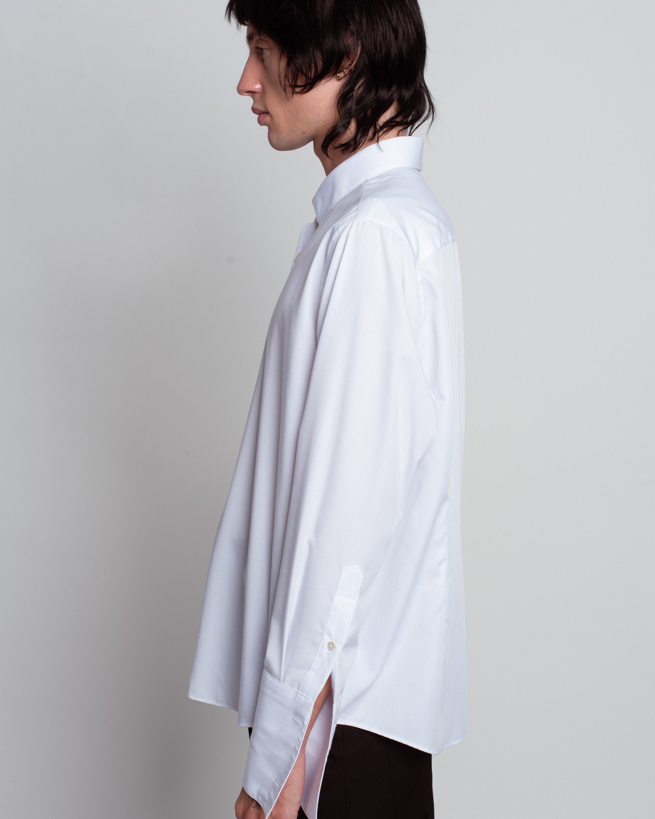 Side view of White Classic Button-Down Shirt in a relaxed silhouette with extended cuffs and a crisp collar, highlighting SHAO New York bespoke tailoring and luxury designer fashion.