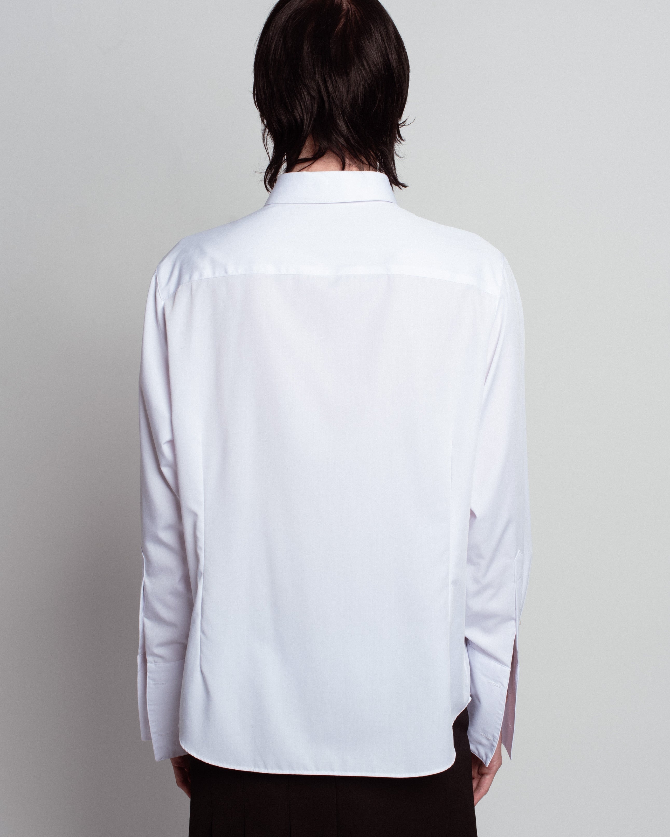 Rear view of White Classic Button-Down Shirt showcasing a smooth, clean back with a structured collar and long sleeves, reflecting SHAO New York bespoke tailoring and luxury designer fashion.