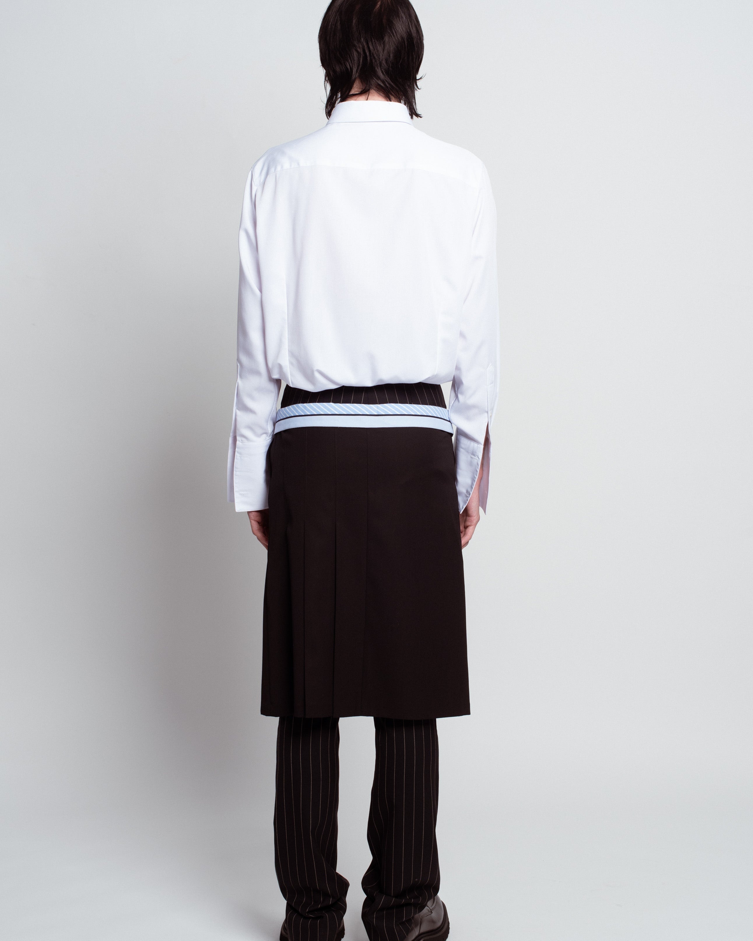 Rear view of White Classic Button-Down Shirt with a structured collar and long sleeves, styled with layered tailored pieces highlighting SHAO New York bespoke tailoring and luxury designer fashion.