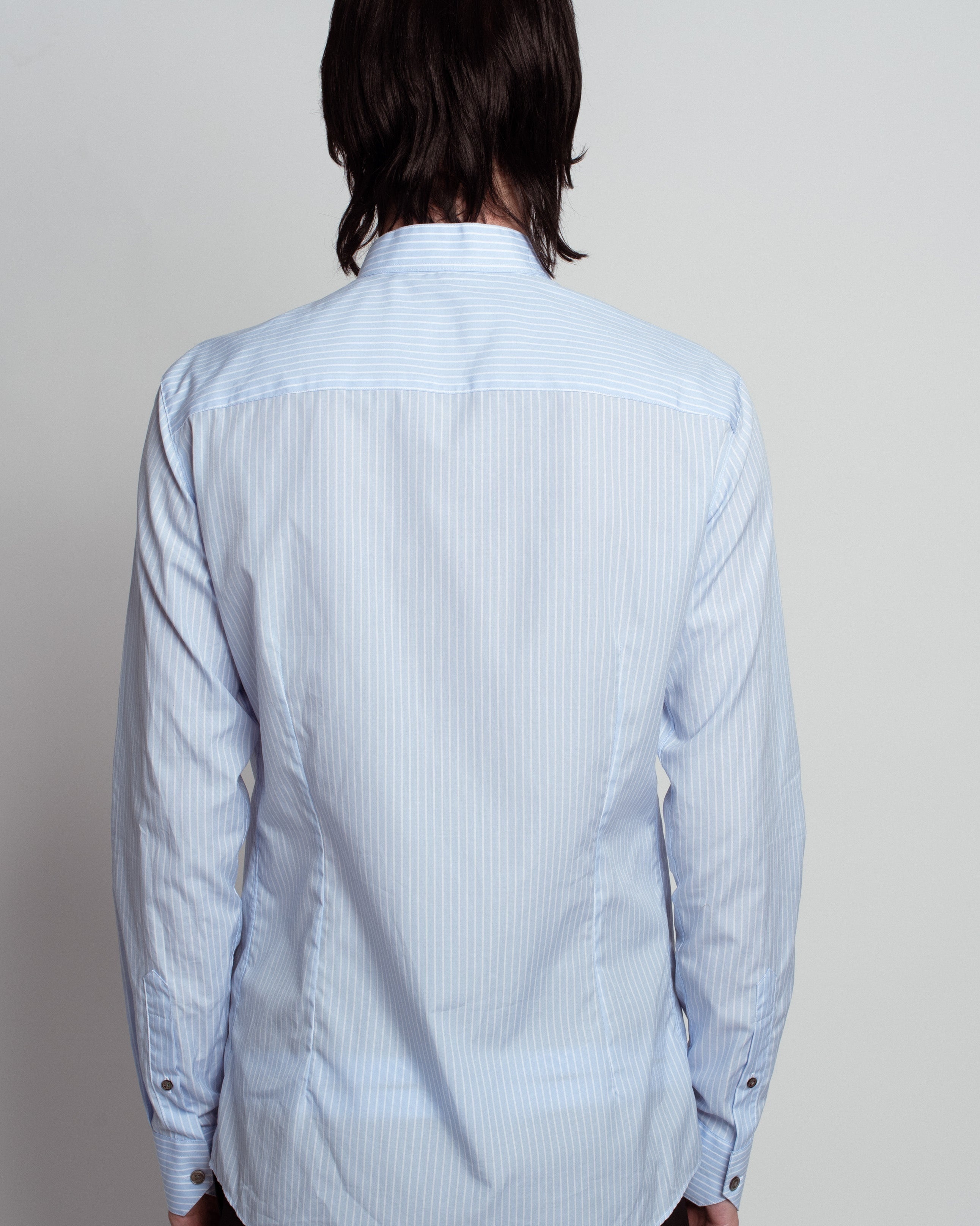 Back view of Blue Striped Band Collar Shirt in soft blue with fine vertical stripes, featuring a tailored fit, subtle band collar, and buttoned cuffs, showcasing SHAO New York bespoke tailoring and luxury designer fashion.
