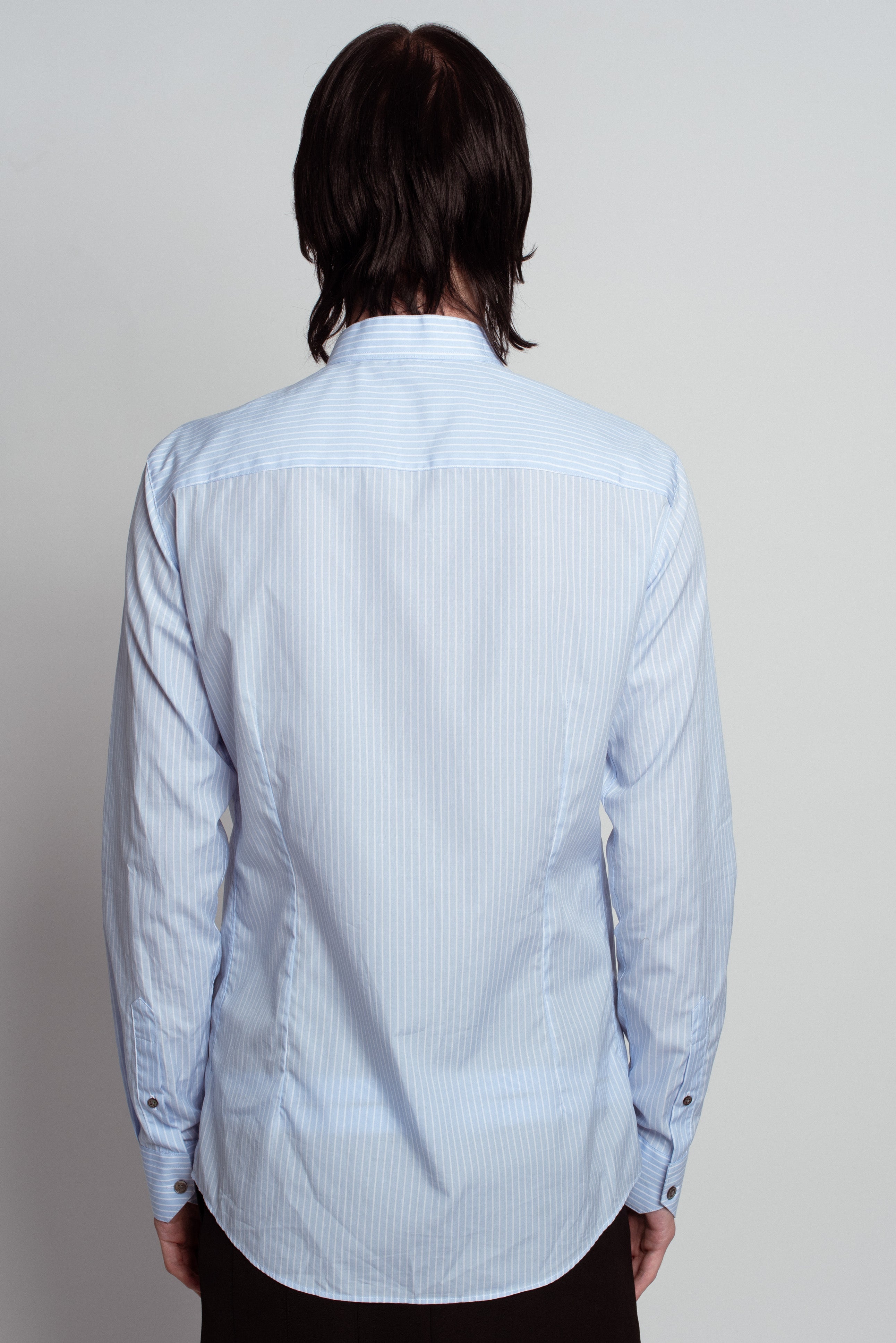 Back view of Blue Striped Band Collar Shirt in soft blue with fine vertical stripes, featuring a tailored fit, subtle band collar, and buttoned cuffs, showcasing SHAO New York bespoke tailoring and luxury designer fashion.