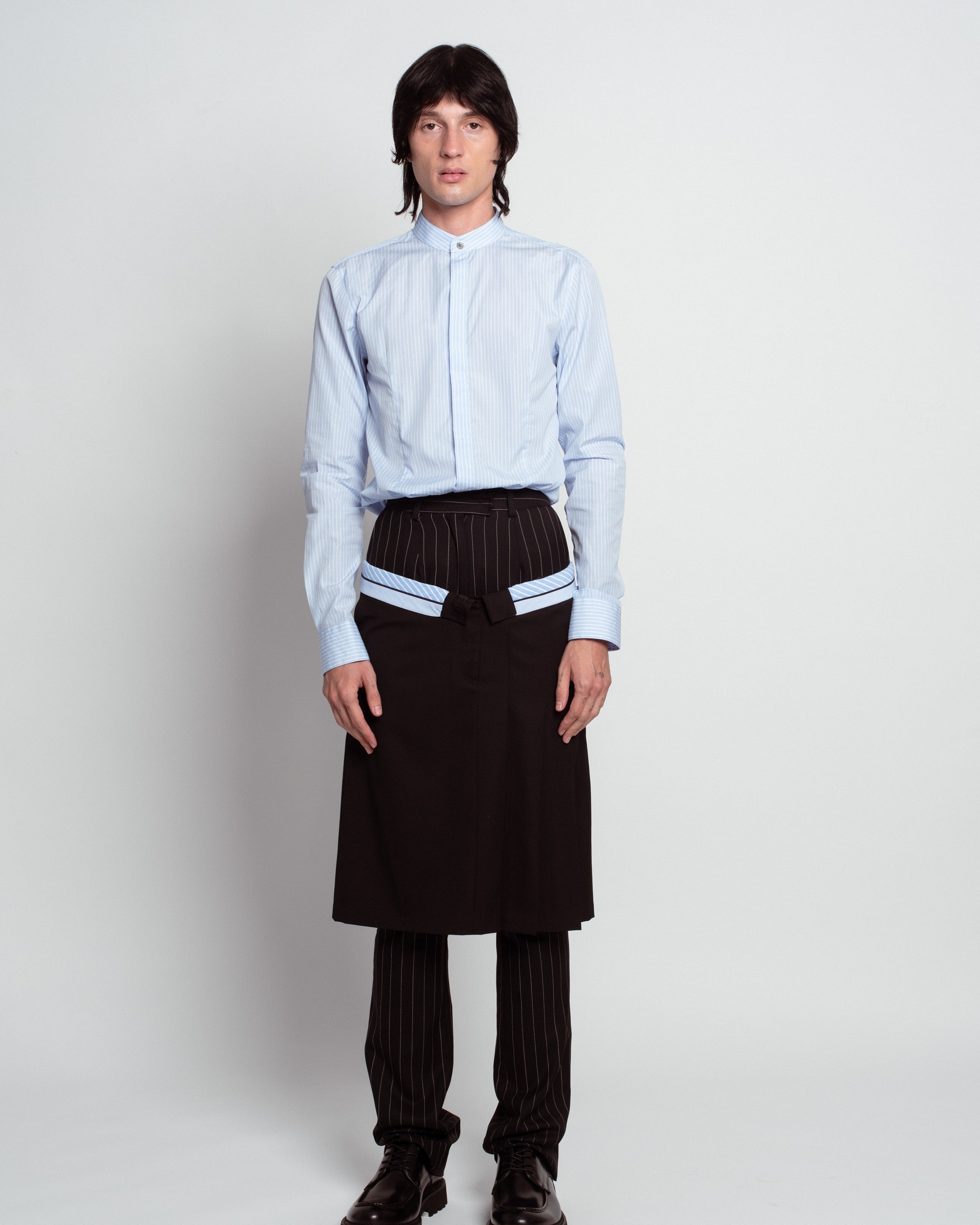 Blue Striped Band Collar Shirt in pale blue with subtle vertical stripes, featuring a stand-up collar, concealed button placket, and tailored fit, exemplifying SHAO New York bespoke tailoring.