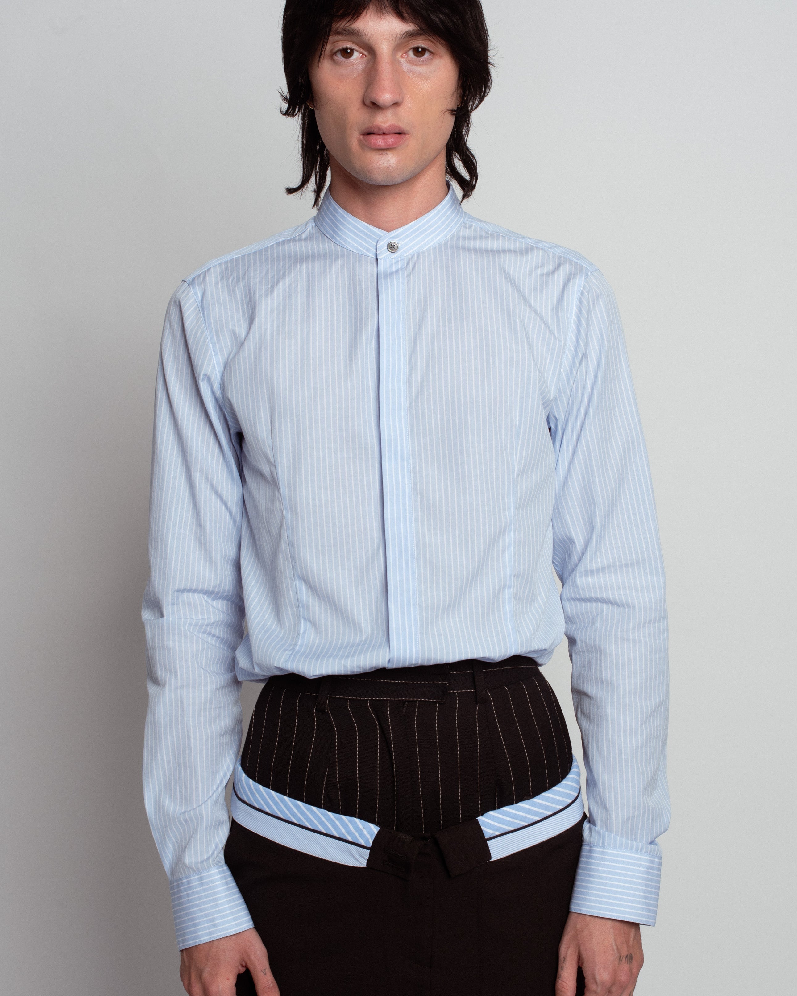 Front view of Blue Striped Band Collar Shirt in soft blue with subtle vertical stripes, featuring a concealed button placket, tailored fit, and crisp cuffs, showcasing SHAO New York bespoke tailoring and luxury designer fashion.