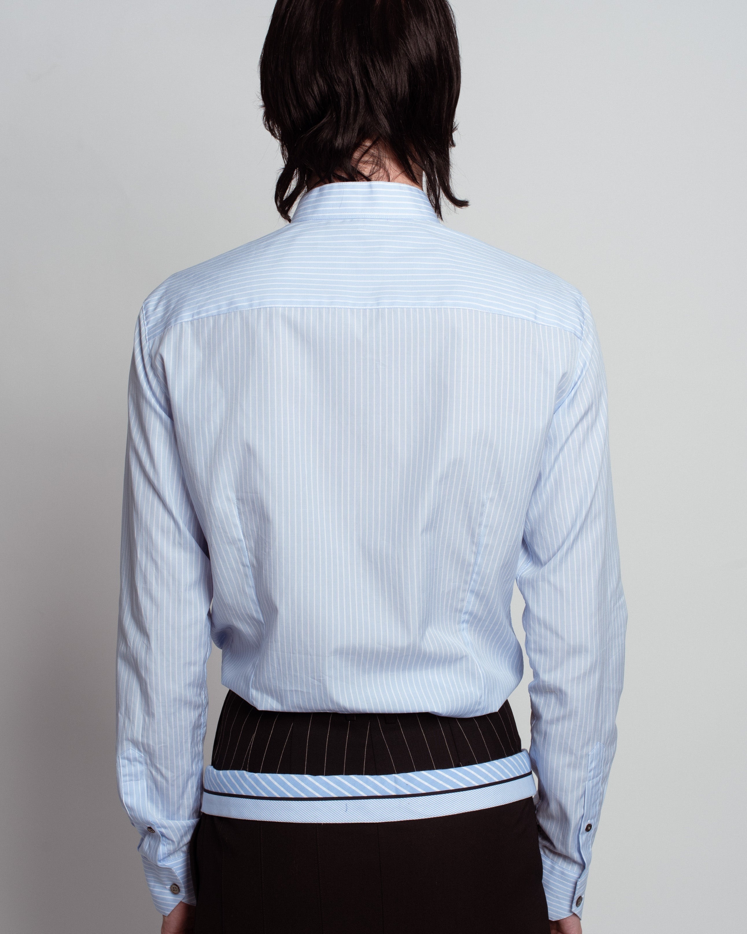 Back view of Blue Striped Band Collar Shirt in light blue with thin vertical stripes, featuring a slim tailored fit, subtle band collar, buttoned cuffs, and refined bespoke tailoring.