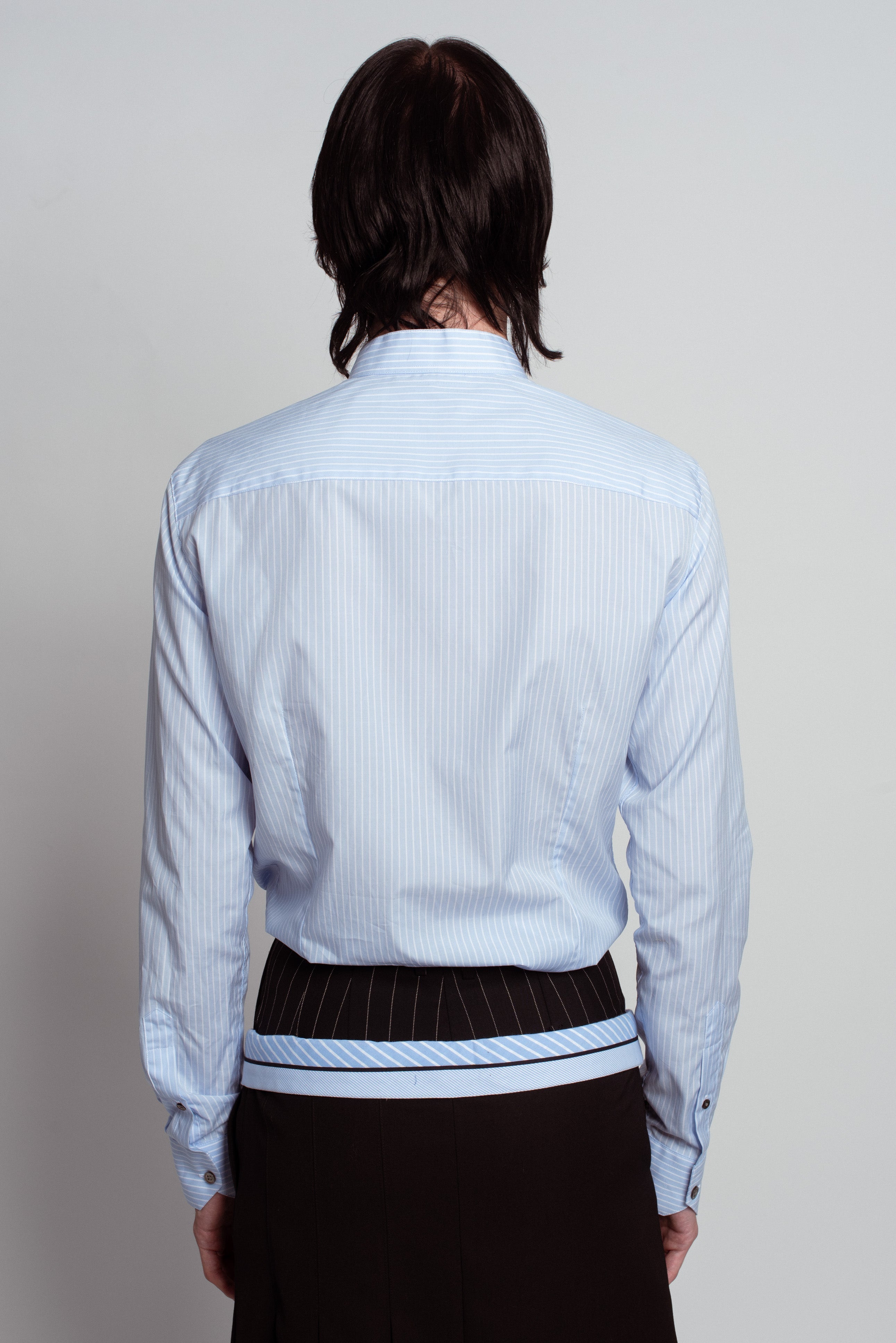 Back view of Blue Striped Band Collar Shirt in light blue with thin vertical stripes, featuring a slim tailored fit, subtle band collar, buttoned cuffs, and refined bespoke tailoring.
