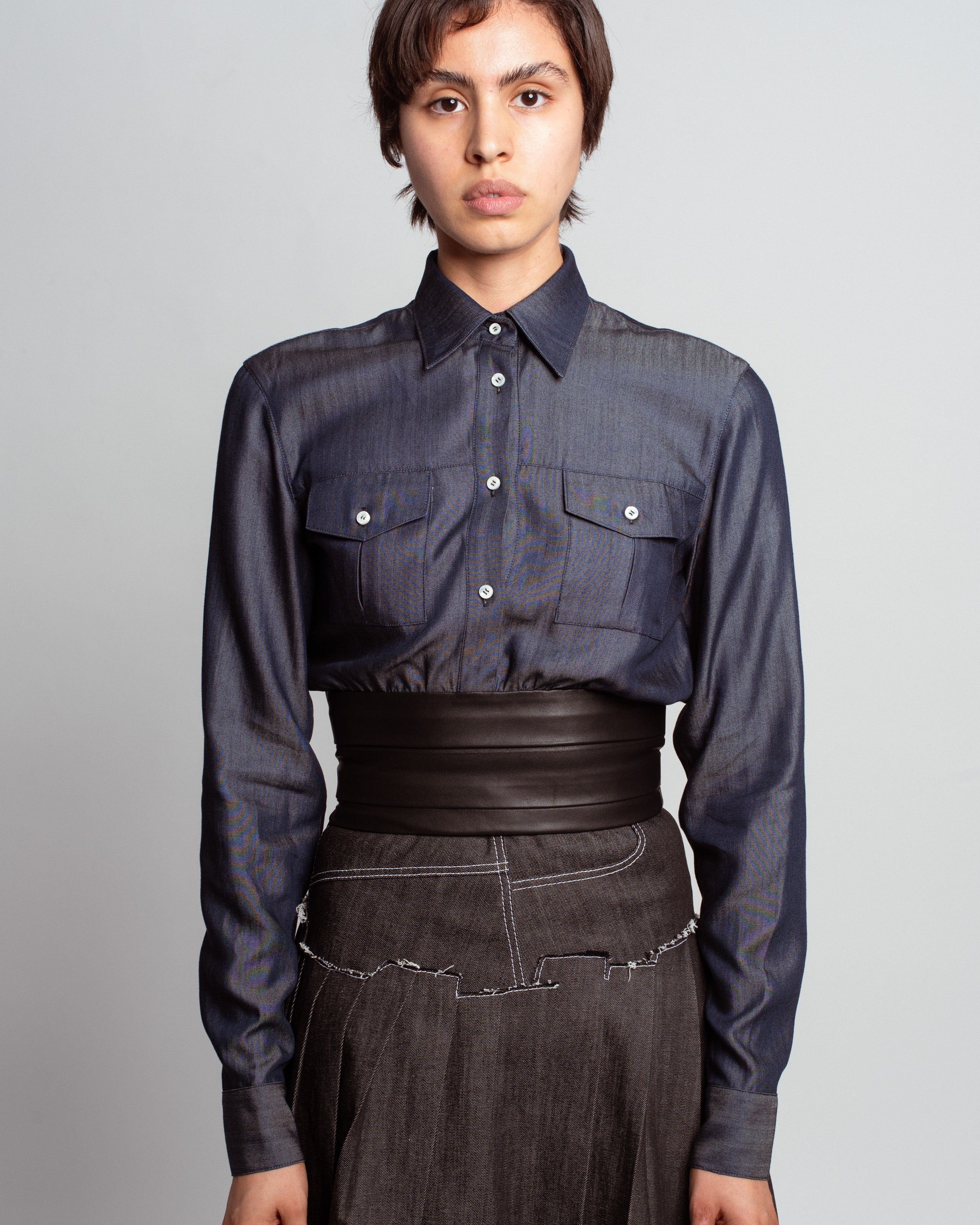 Front view of Midnight Blue Shirt with Leather Waistband showcasing structured chest pockets, sharp collar, and a wide sculptural leather waist detail, exemplifying SHAO New York bespoke tailoring and luxury designer fashion.