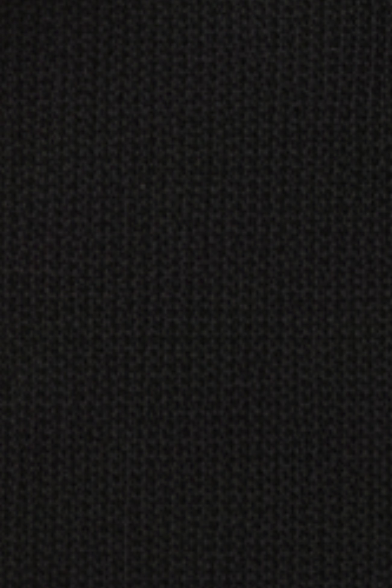 Close-up swatch of black French terry fabric with cargo pocket panel texture and oversized SHAO fit detailing.