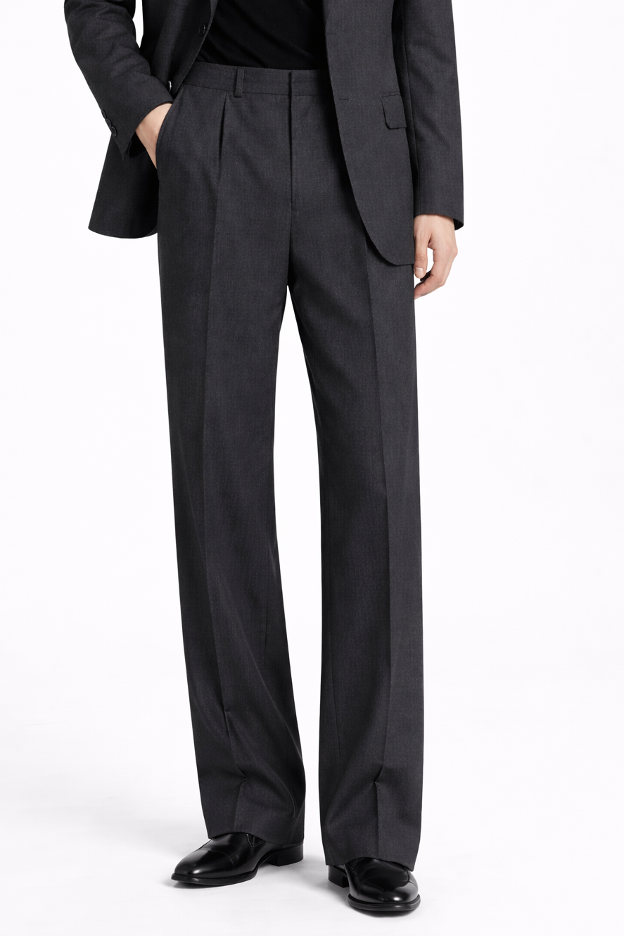Close-up frontal view of Charcoal Grey Relaxed Trousers featuring a high-rise waist, subtle pleats, and a wide leg silhouette styled with polished black shoes, reflecting SHAO New York bespoke tailoring and luxury designer fashion.