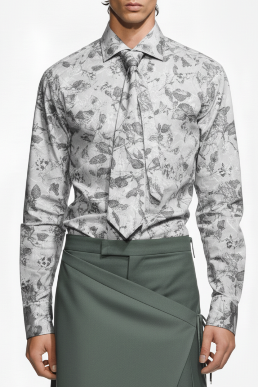 Person wearing a patterned shirt and green skirt on a white background