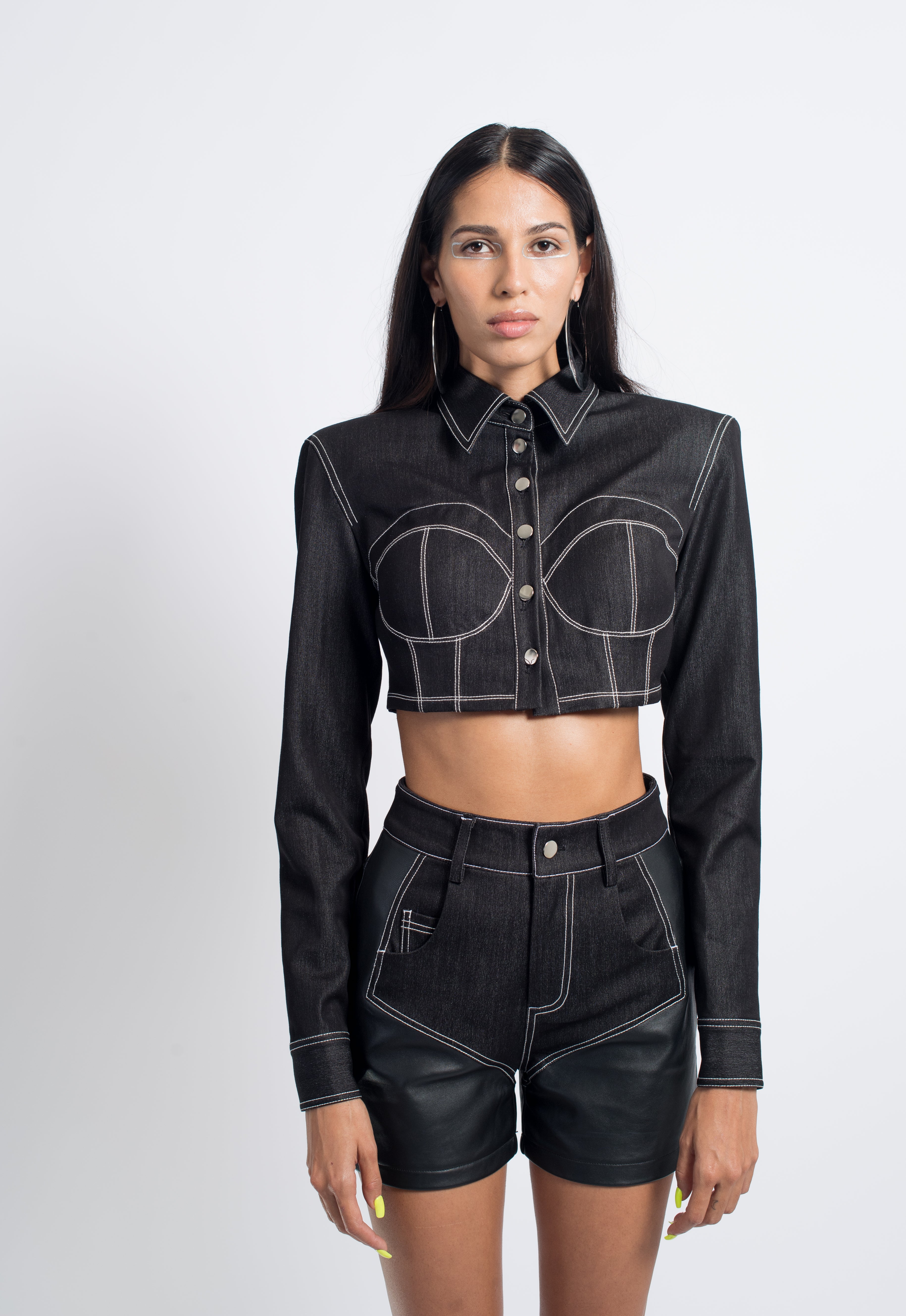 Model wearing Cropped Denim Jacket with structured silhouette and contrast white stitching, paired with high-waisted shorts featuring leather panels, embodying SHAO New York bespoke tailoring and luxury designer fashion.
