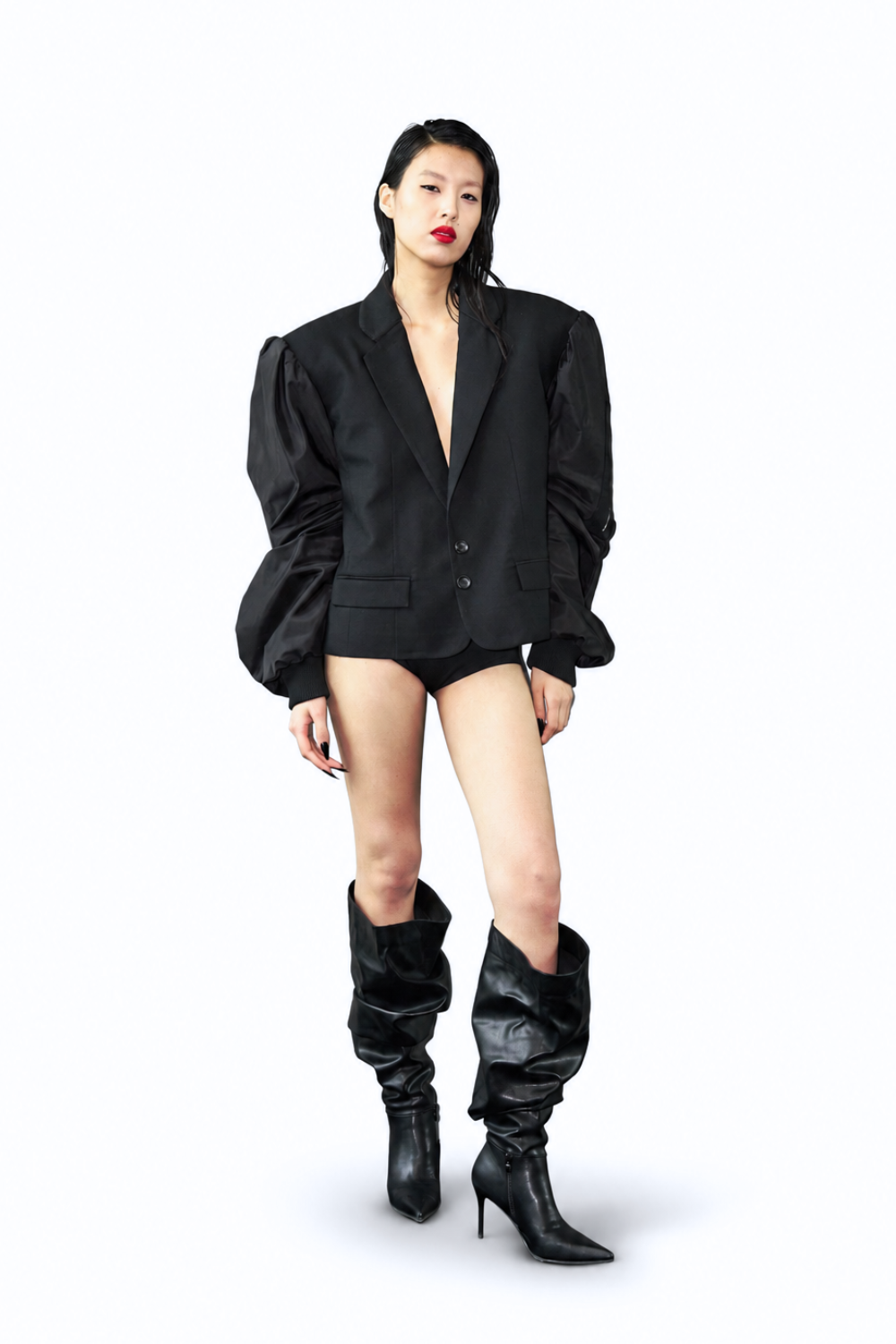 Model wearing the Hybrid Bomber Sleeve Blazer in black, featuring voluminous satin sleeves, sharp lapels, a two-button closure, and a sculptural silhouette emphasizing bespoke New York designer tailoring.