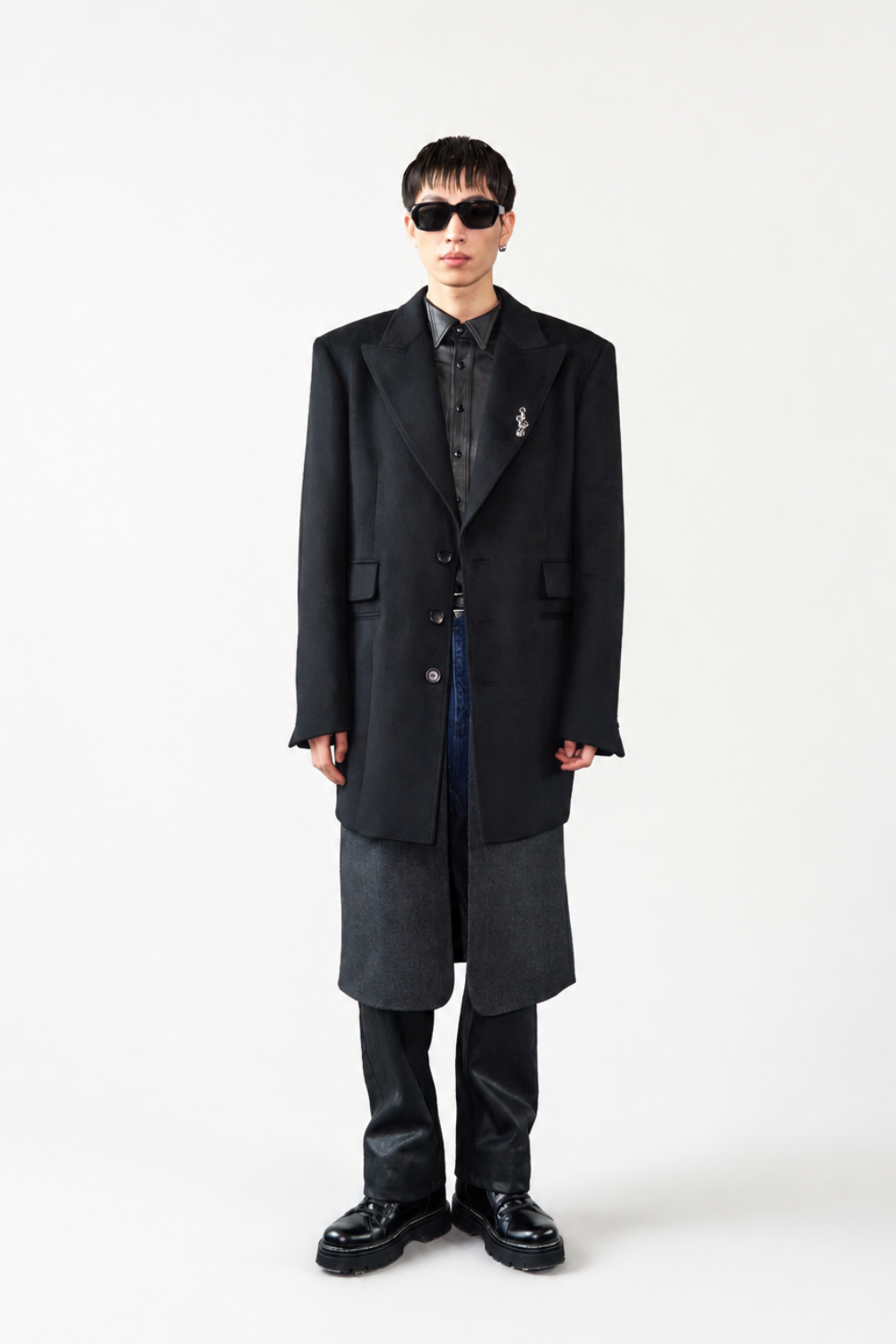 Model wearing the Cashmere Silk Double Layered Coat in black with an extended hemline, structured lapels, button closure, and sharp tailoring, highlighting SHAO New York bespoke tailoring and luxury designer fashion.