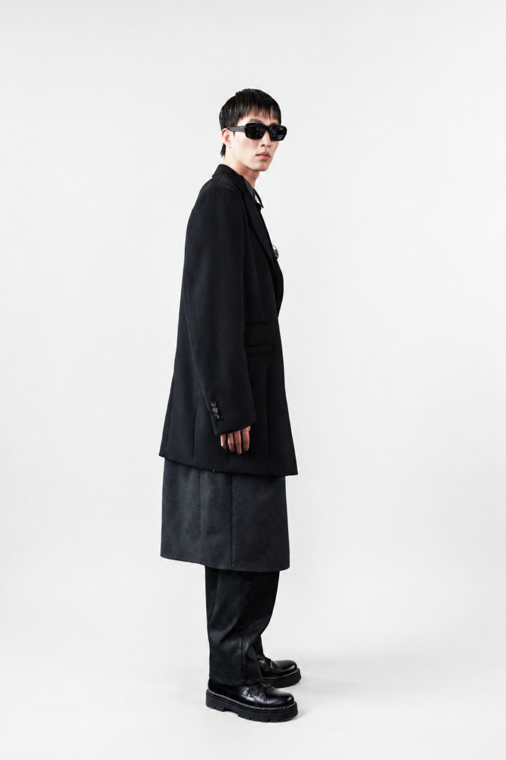 Model wearing the Cashmere Silk Double Layered Coat in black with an extended hem, relaxed tailored fit, and buttoned cuffs, showcasing SHAO New York luxury bespoke tailoring.