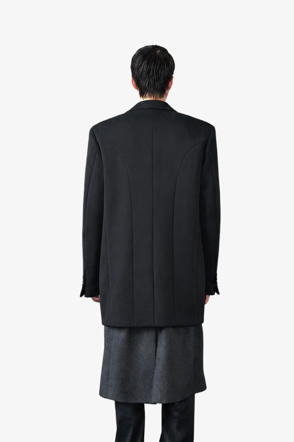 Model seen from behind wearing the Cashmere Silk Double Layered Coat in black, showcasing a tailored back panel, structured shoulders, and a sleek, sculptural silhouette by SHAO New York bespoke tailoring.