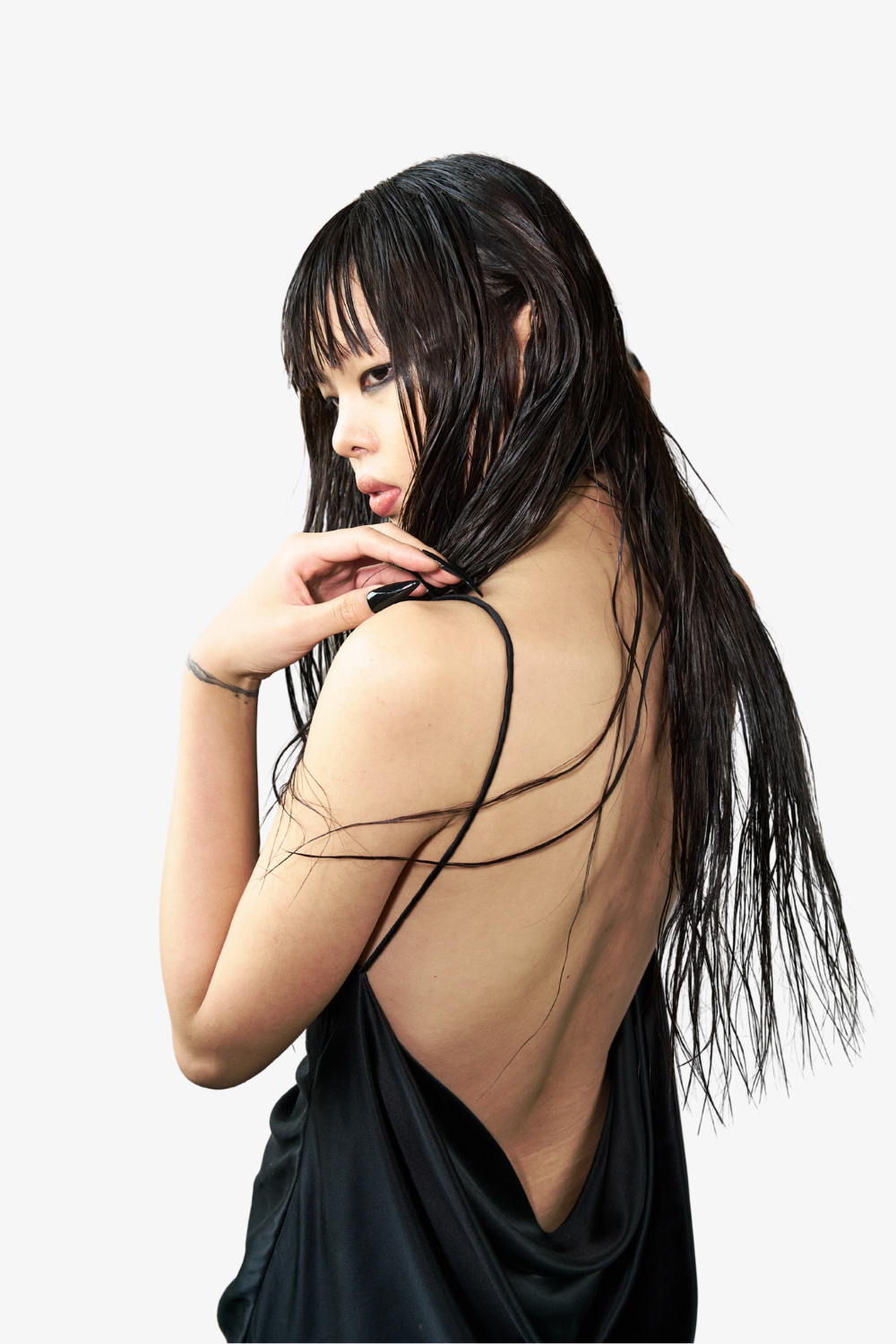 Model wearing the Pierced Cowlback Slip Dress in smooth black satin with a dramatic open back and delicate spaghetti straps, highlighting SHAO New York bespoke tailoring and luxury designer fashion.