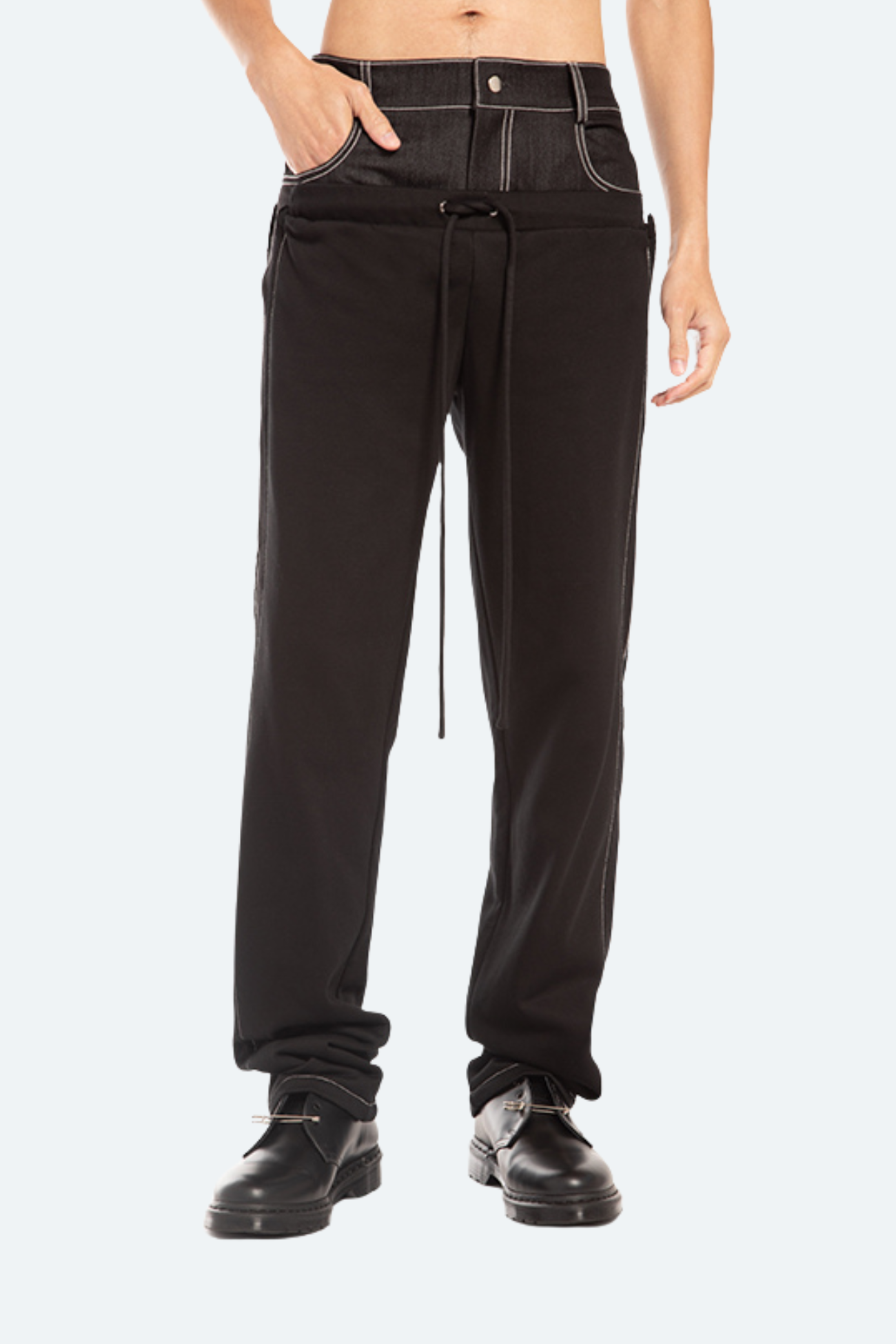 Front view of black hybrid trousers with structured denim waistband.