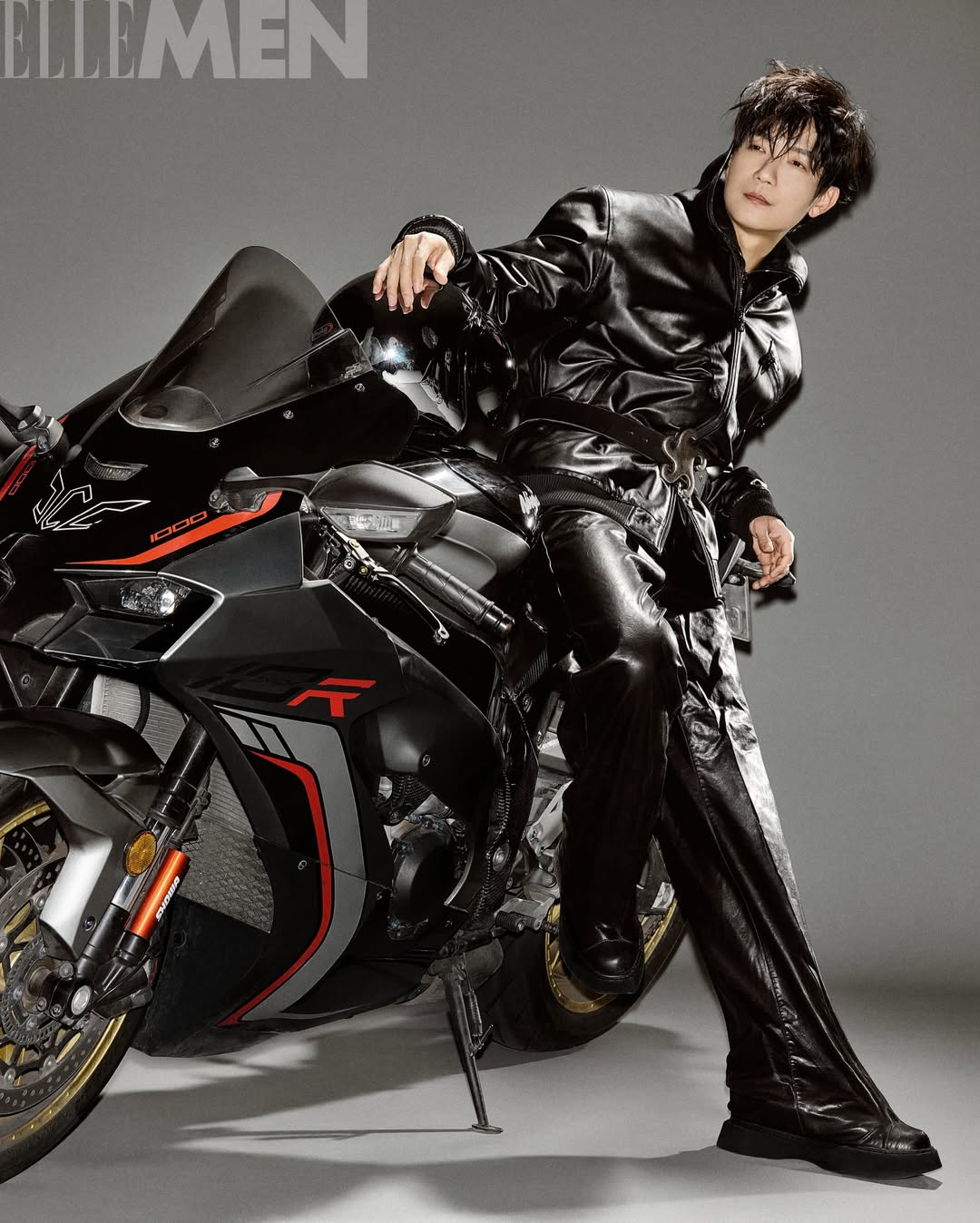 Man in black leather outfit sitting on a black motorcycle