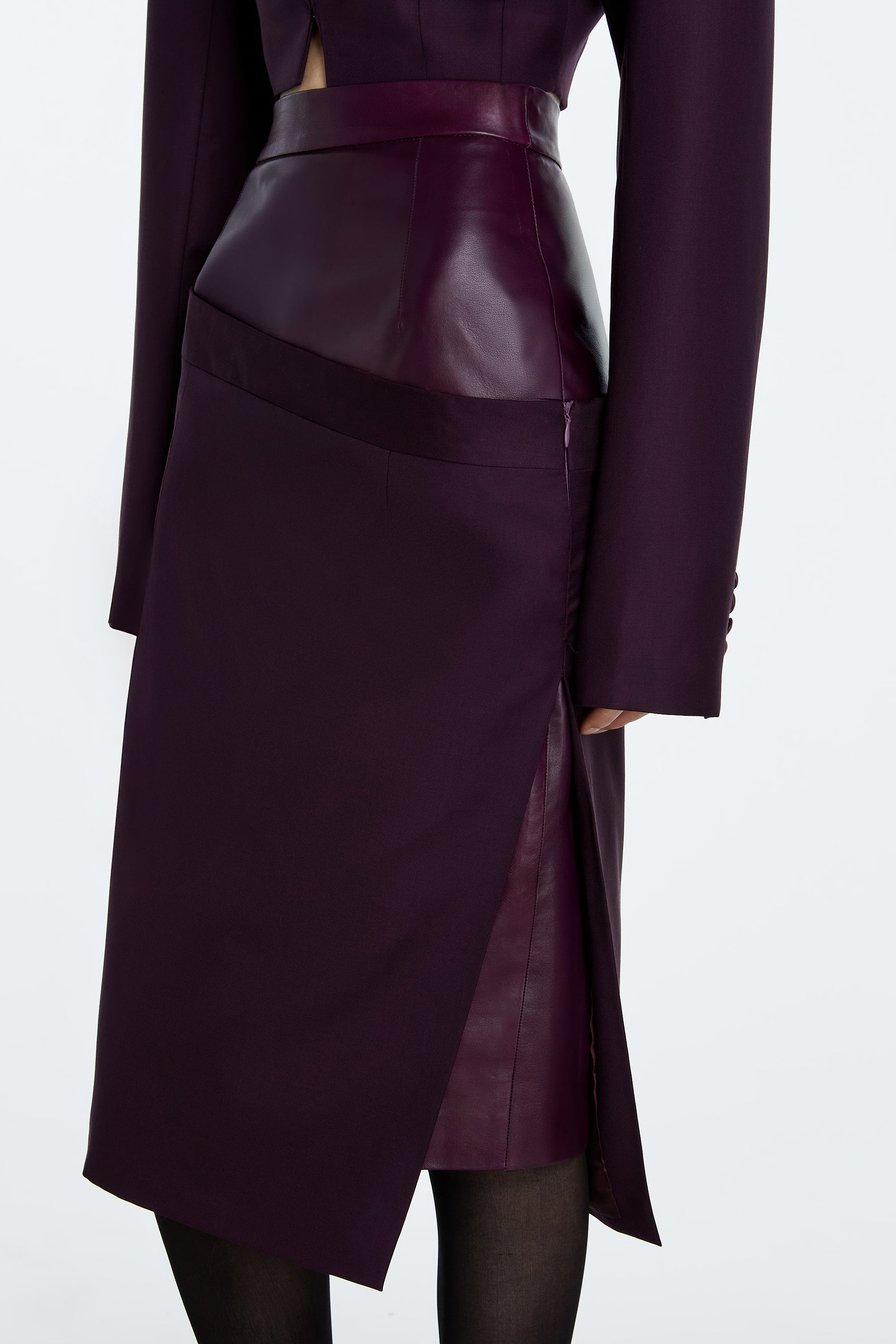 Aubergine Dual-Layer Asymmetrical Draped Skirt with leather and wool in a rich aubergine hue and sculptural silhouette.