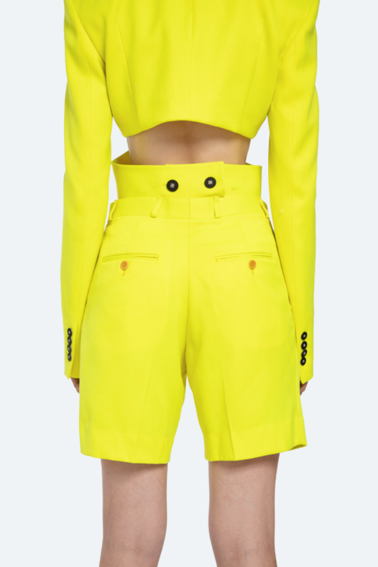 Back view of neon tailored shorts with clean construction.