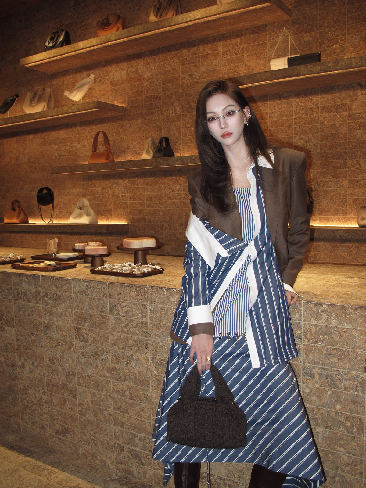 Woman in a stylish outfit standing in a decorative interior setting